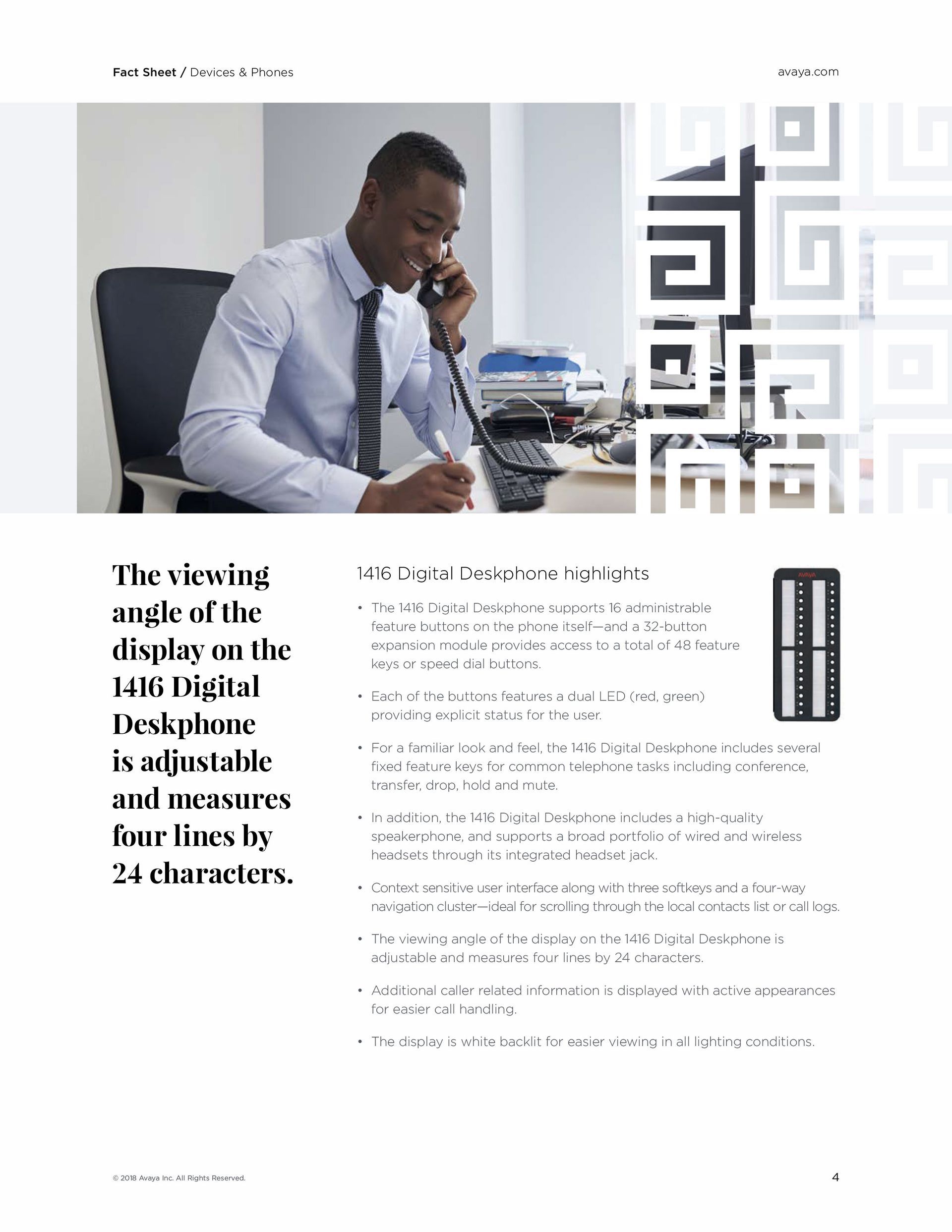 A man is sitting at a desk talking on a phone.