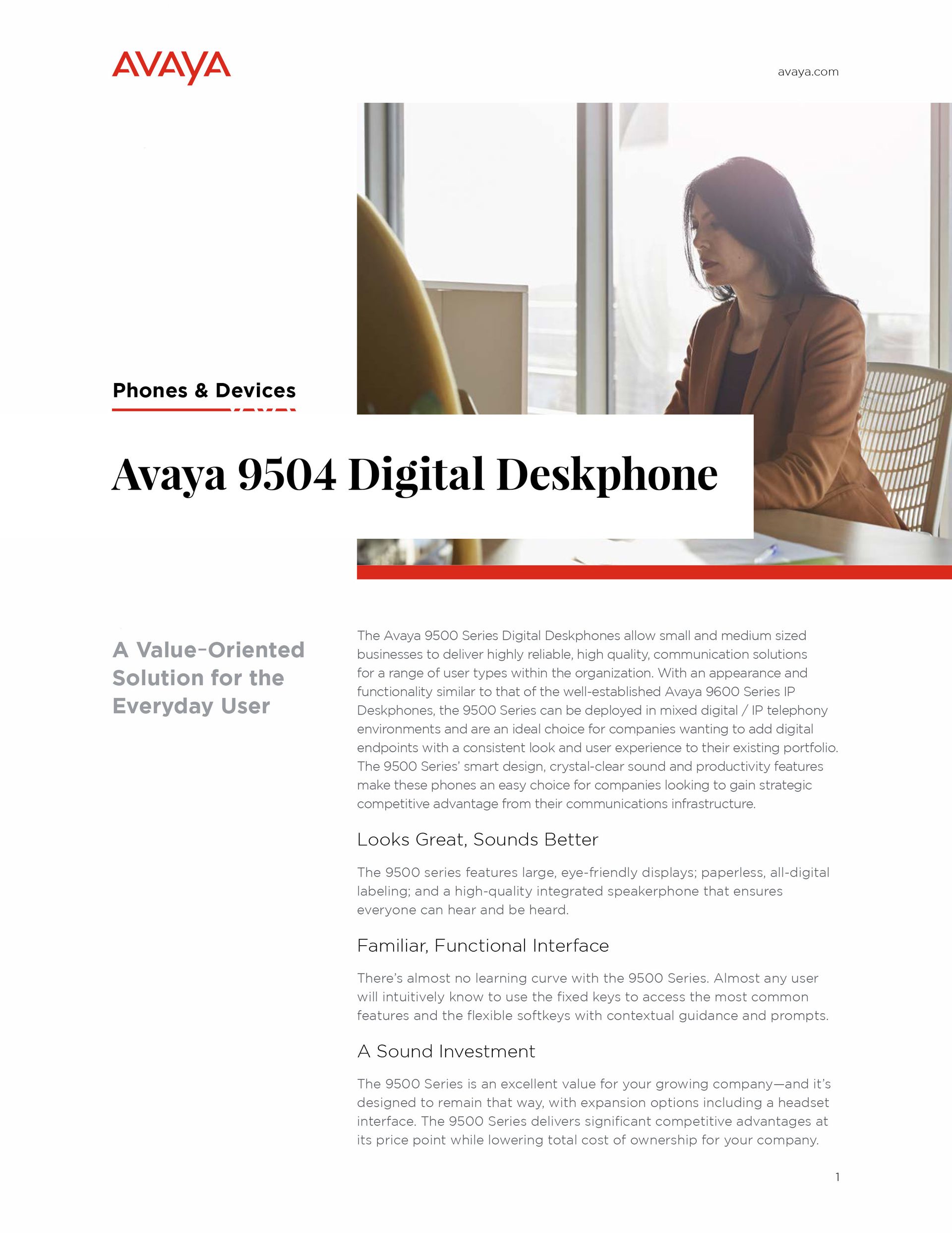 A woman is sitting at a desk in front of a computer.