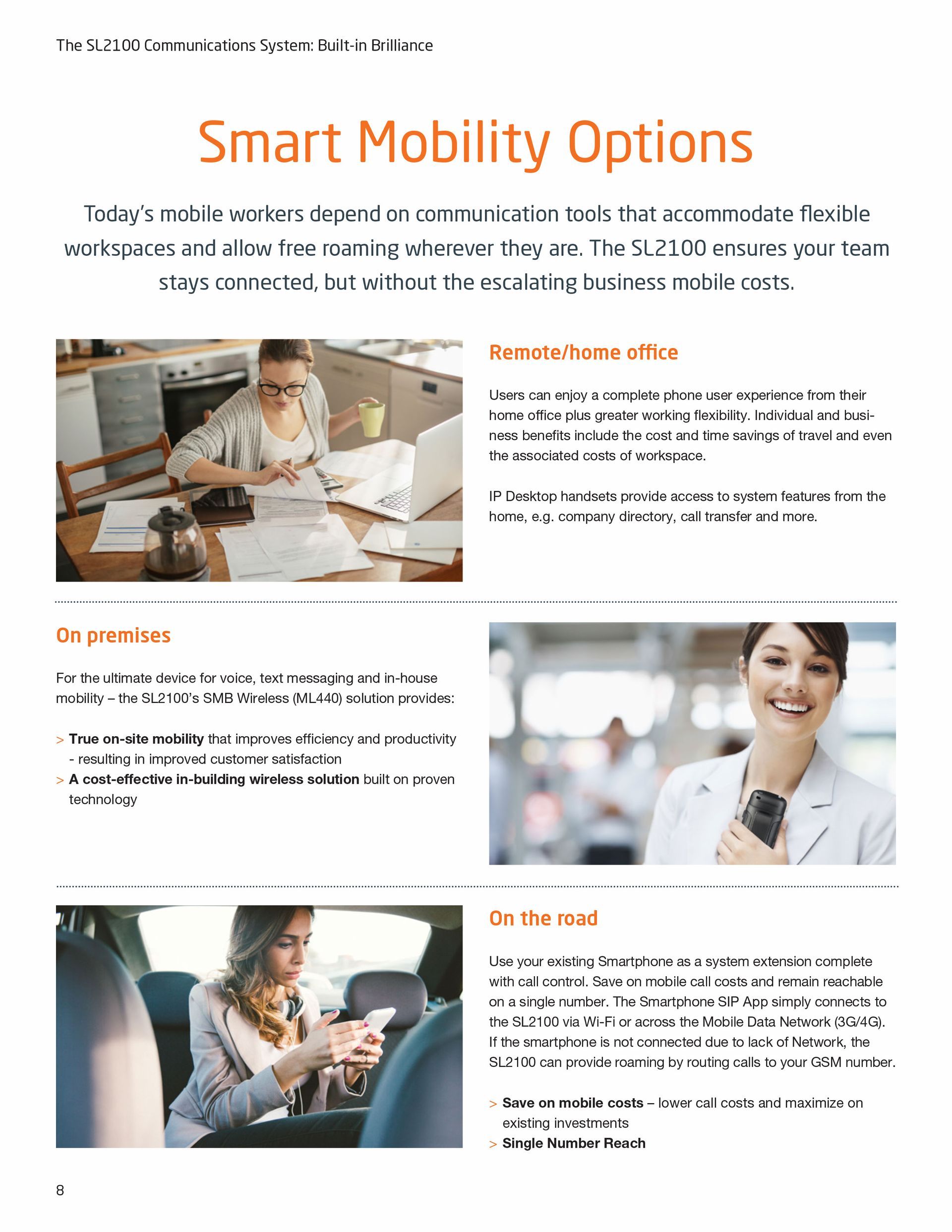 A woman is sitting at a desk looking at her phone.