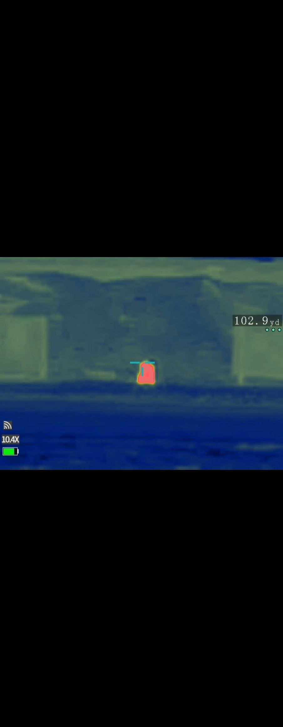 A blurry picture of a red object in the middle of a body of water.