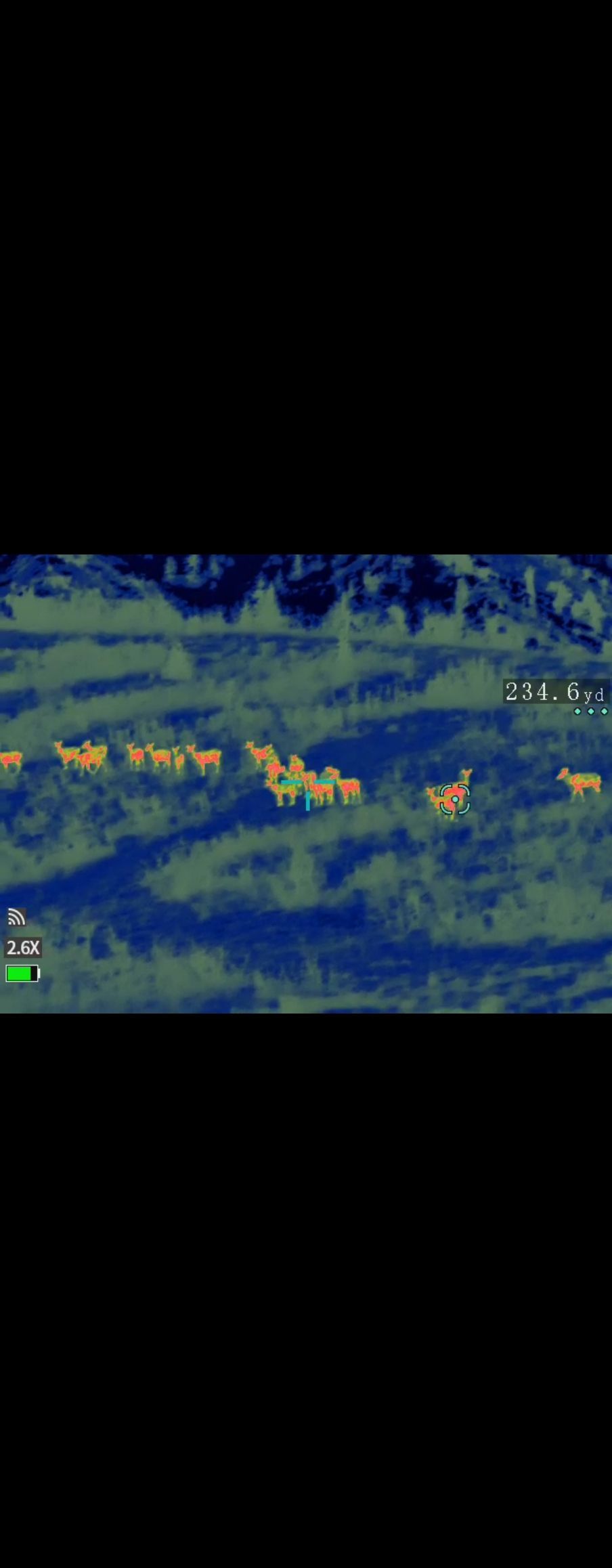 A blurred image of a field of grass and trees with a black background.