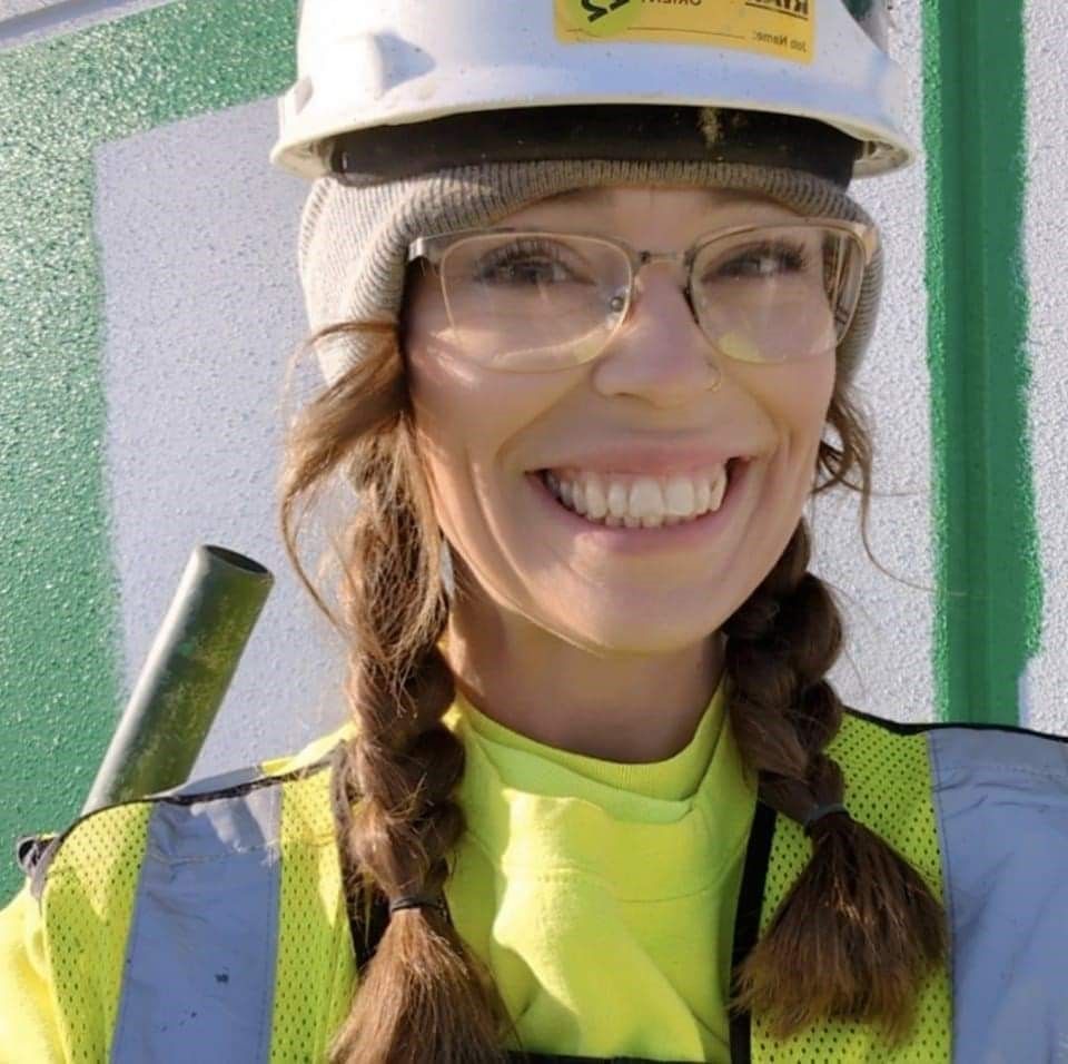 Close-up portrait of NCIFTI graduate, Christina Harms, smiling and wearing a white hard hat.