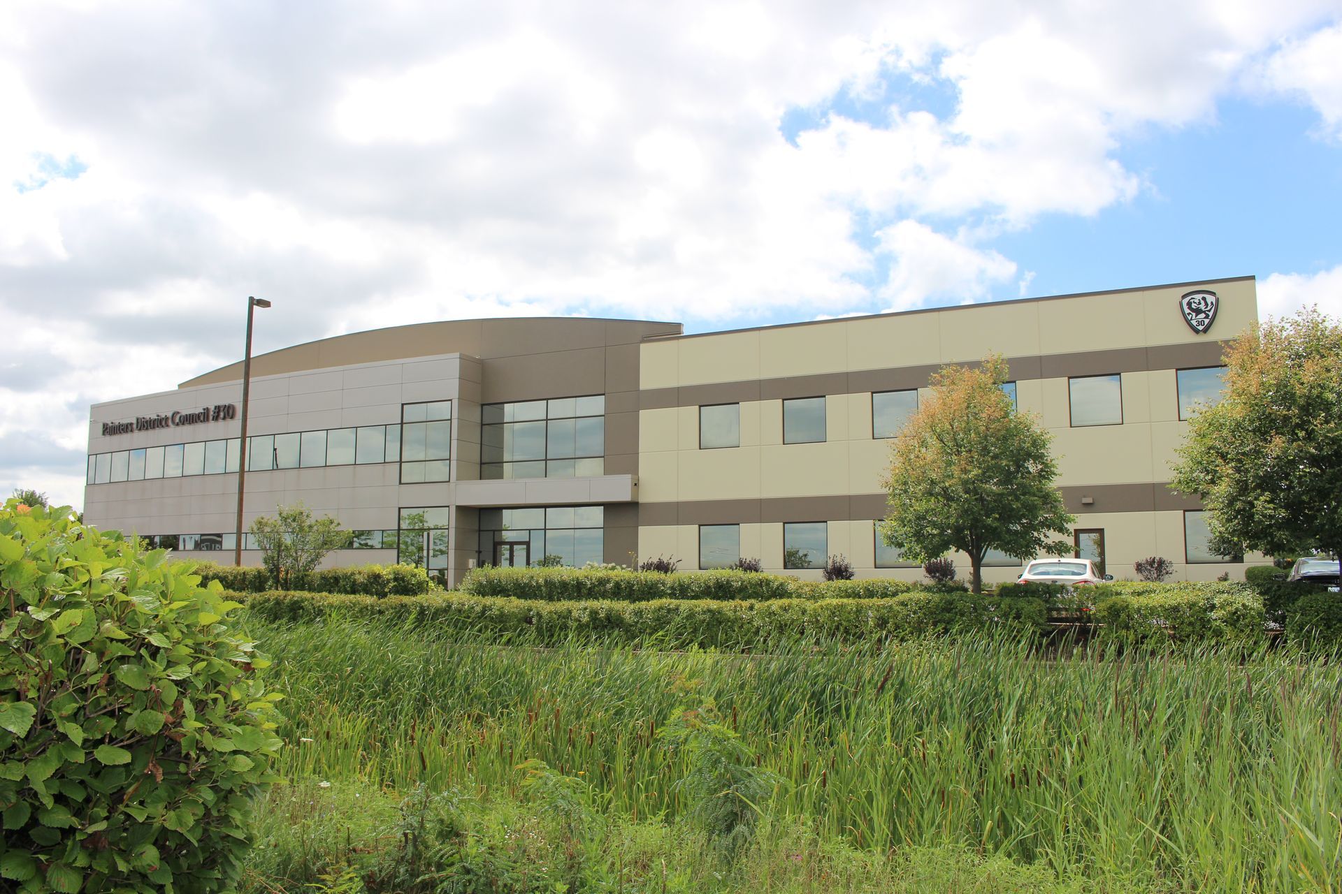 The exterior of the PDC 30 building, a modern two-story professional building surrounded by green landscape.