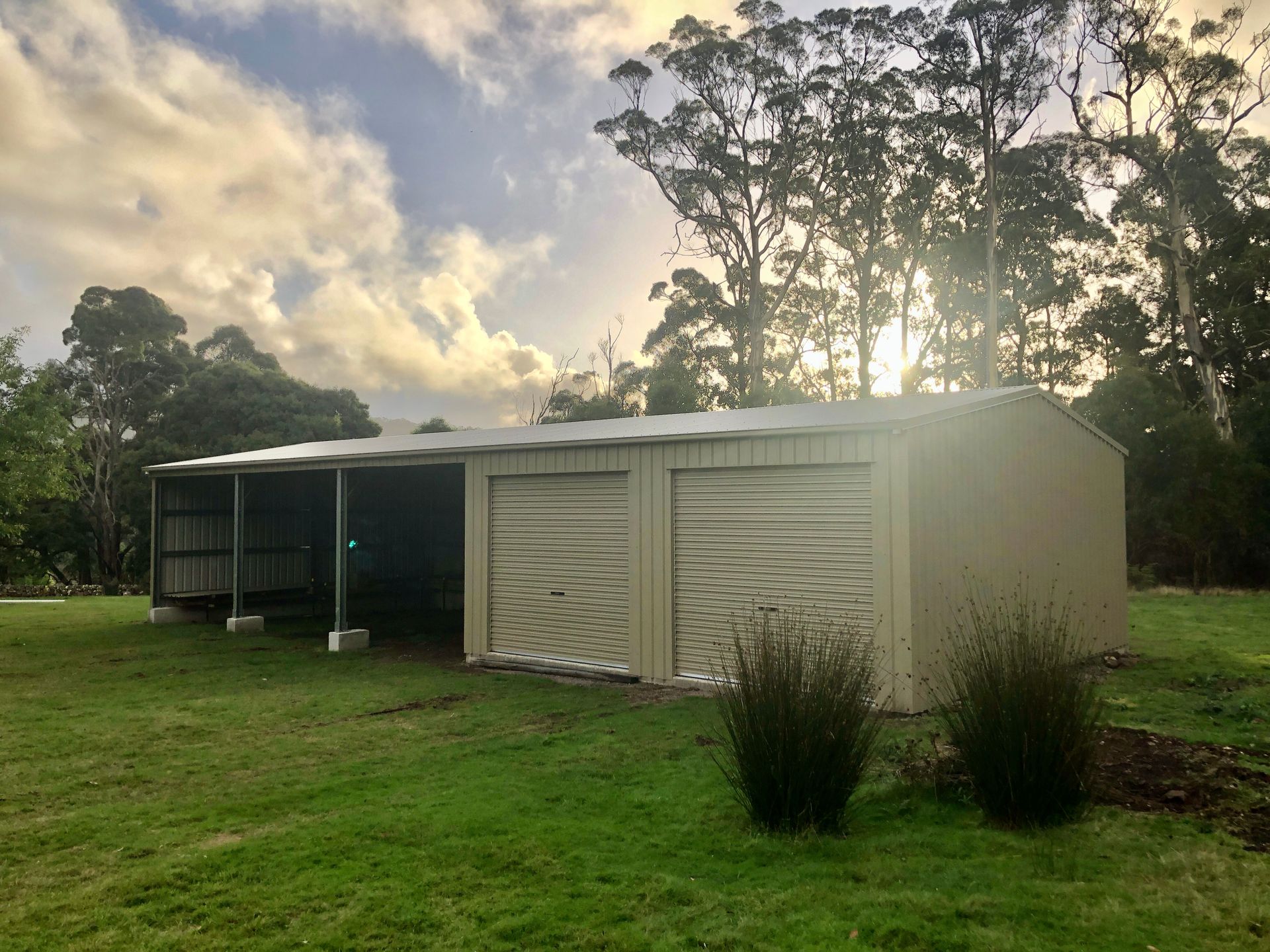 A Shed Is Sitting In The Middle Of A Lush Green Field — Urbon Sheds in Casino, NSW