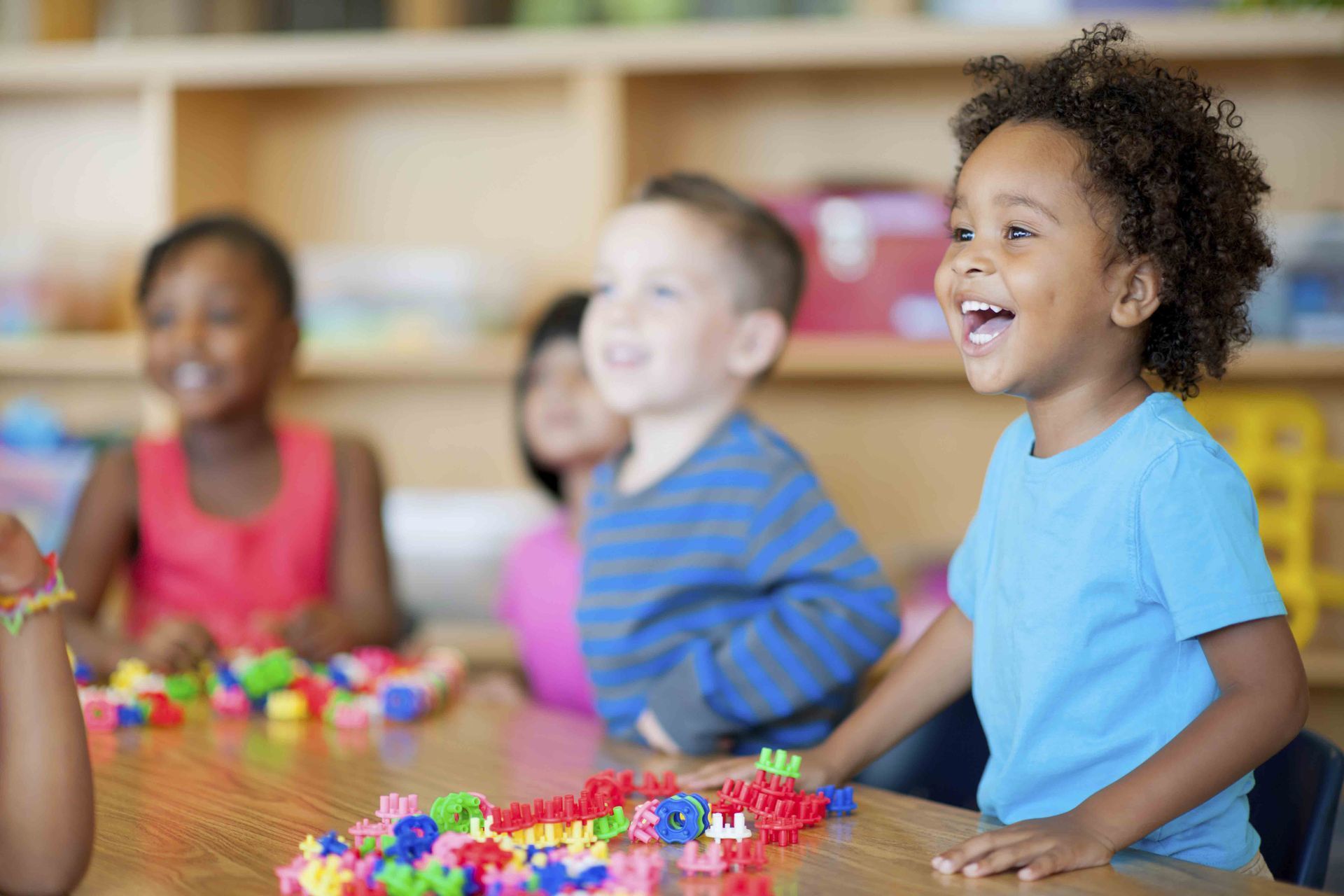 Kindergarten children playing with toys at Kids Kampus Preschool Program in Naperville, IL, fosterin