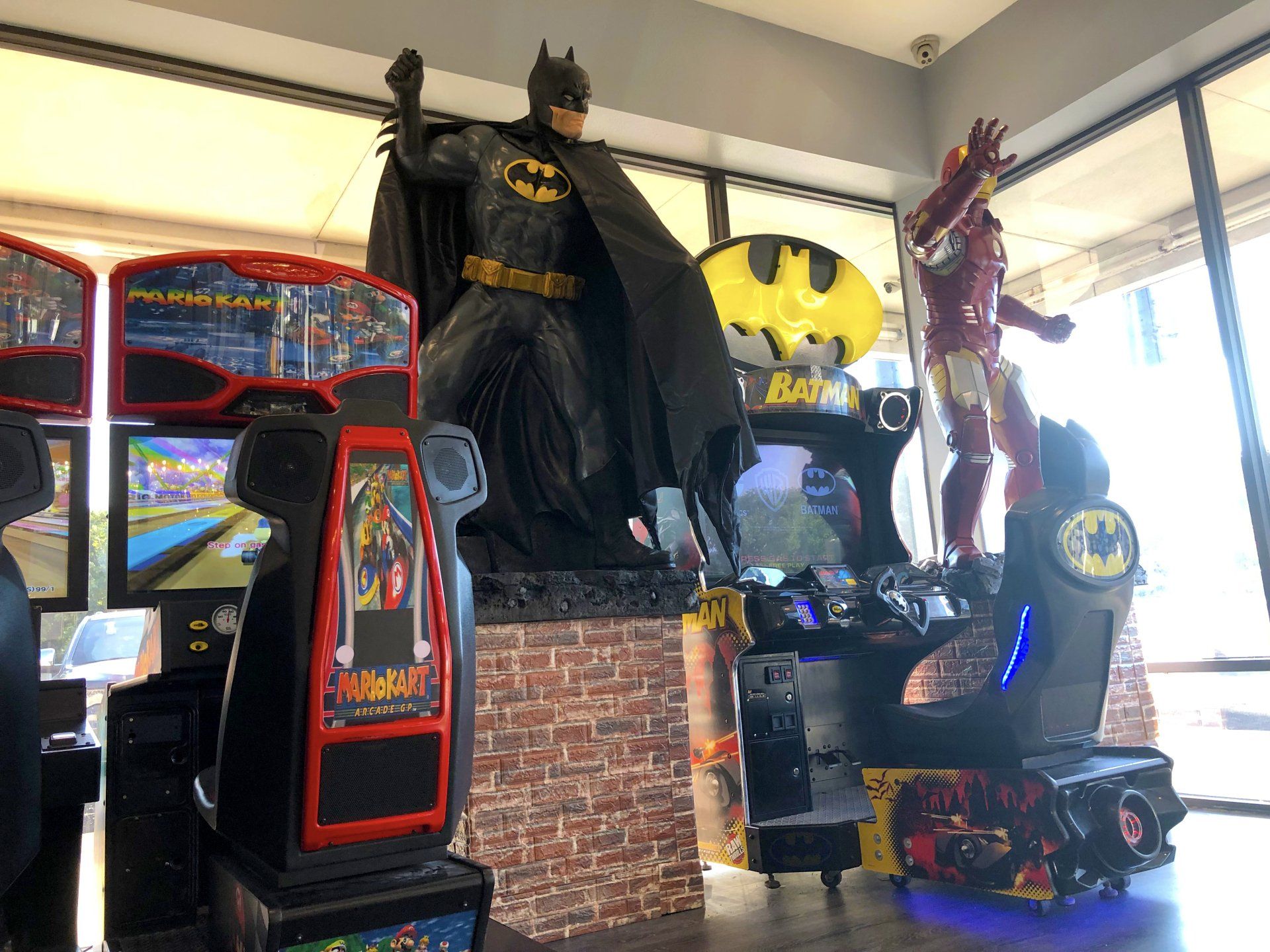 Lucent Dentistry in Austin Tx. There is a statue of batman and iron man in an arcade.