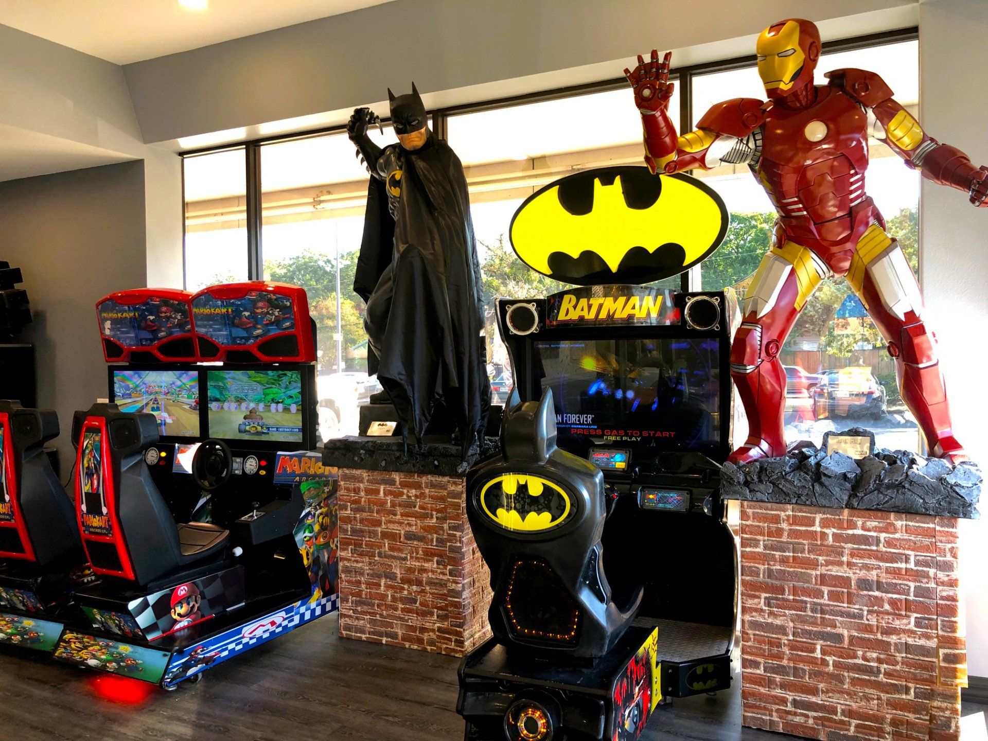 Lucent Dentistry in Austin Tx. A room filled with arcade games and statues of batman and iron man.