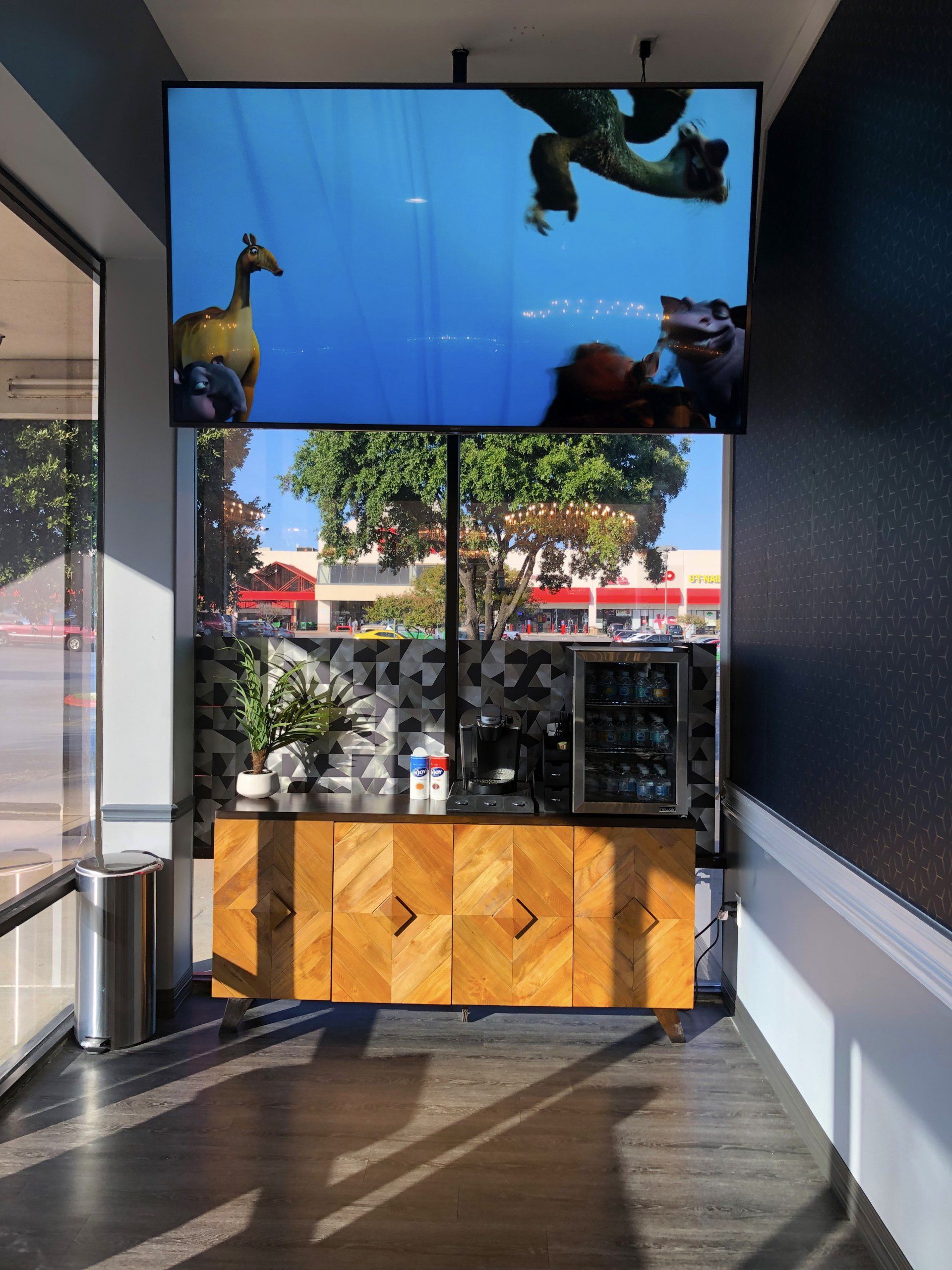 Lucent Dentistry in Austin Tx. A corner of a room with a display of shrek on the wall