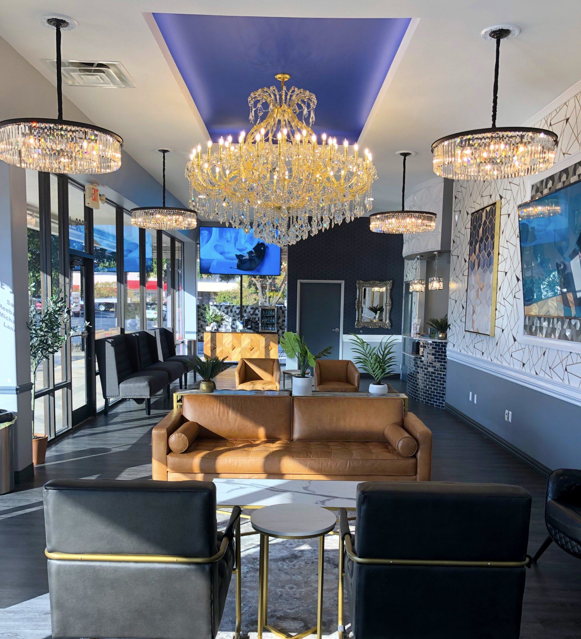 Lucent Dentistry in Austin Tx. A living room with a couch and chairs and a chandelier hanging from the ceiling