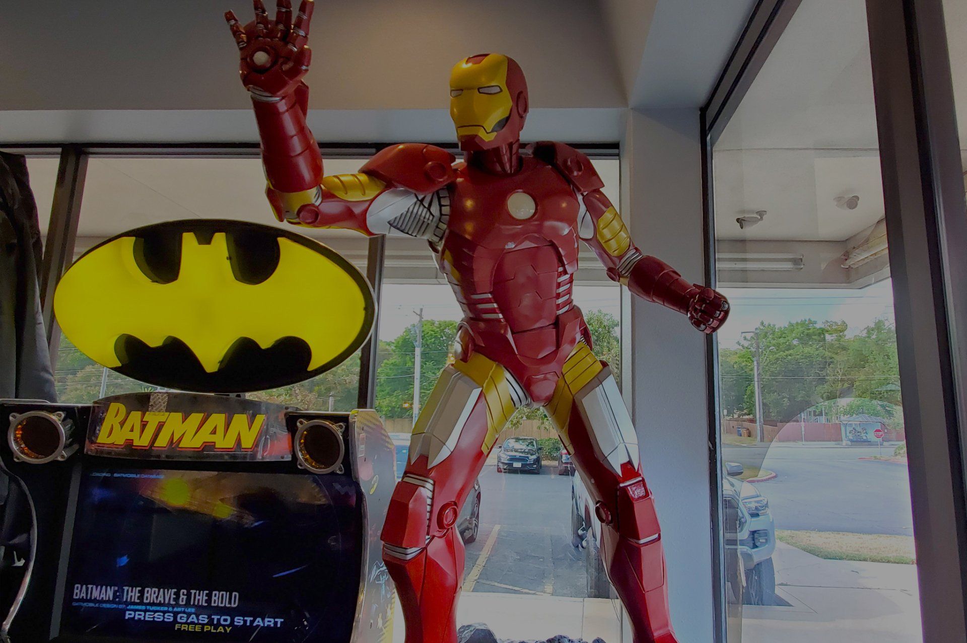 Lucent Dentistry in Austin Tx.  A statue of iron man is standing in front of a batman sign.