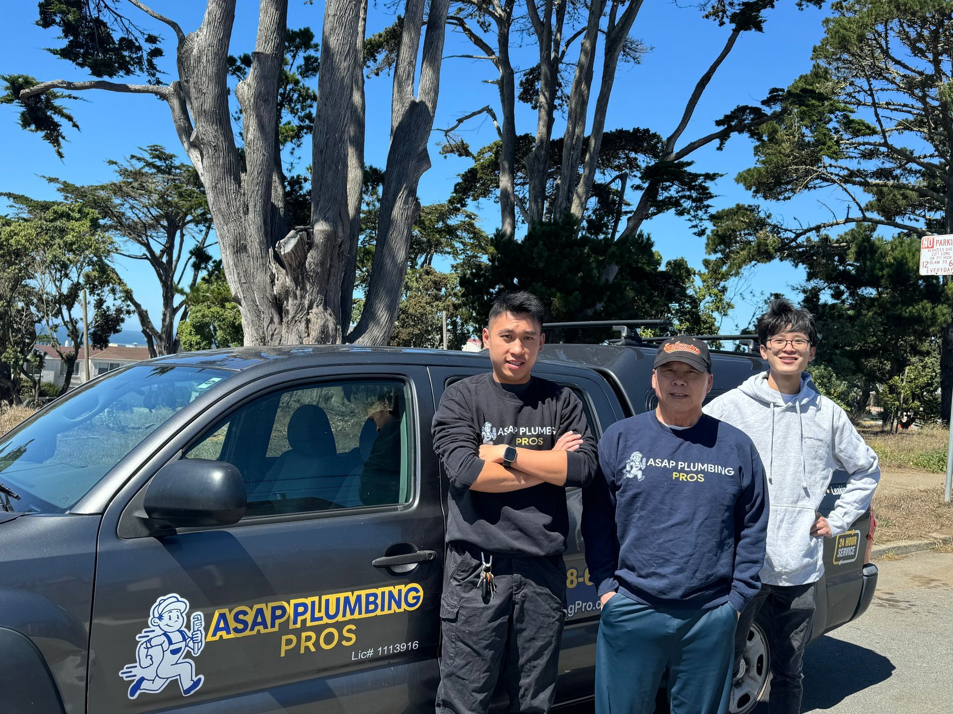 Three men are standing in front of a truck that says asap plumbing pros