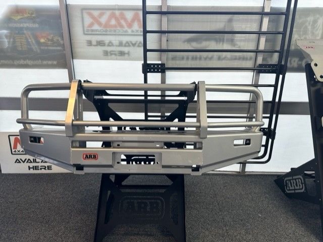 Silver Arb Bull Bar With a Black Cargo Rack, Displayed Indoors — Stay on Track 4X4 Accessories in Gladstone Central, QLD