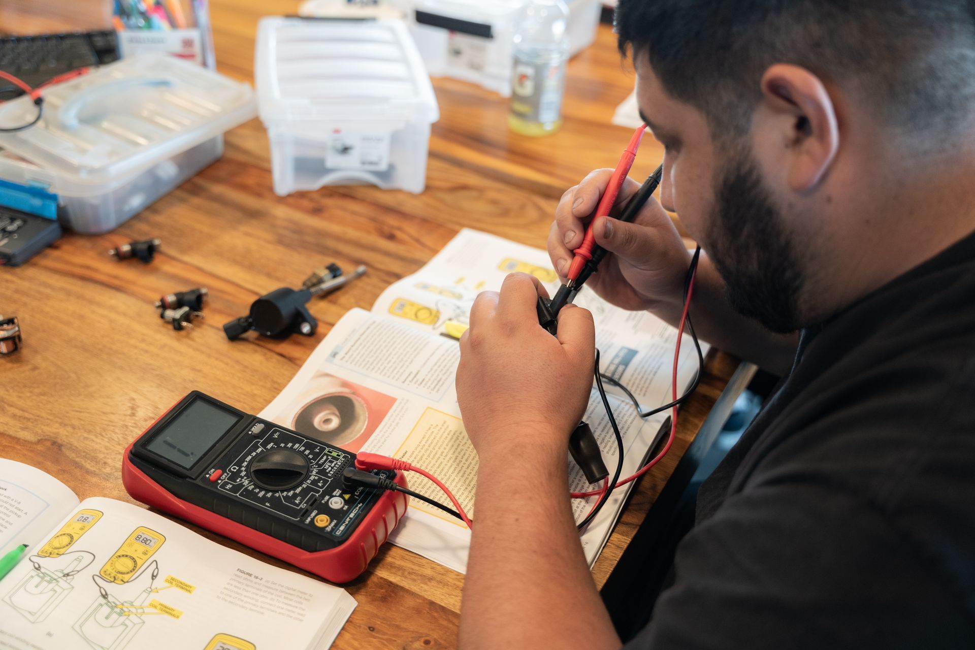 man using a volt meter on a device