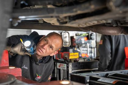 Mechanic looking under car | Big Apple Automotive