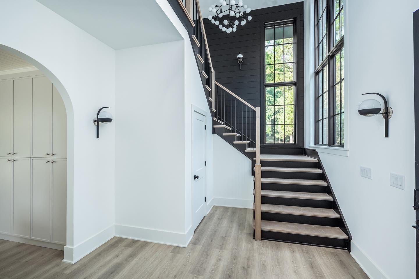 A hallway with stairs leading up to the second floor of a house.