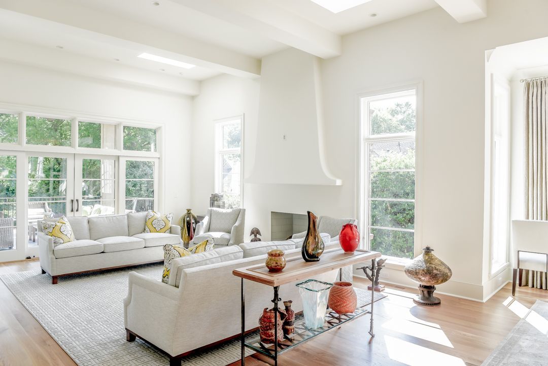 a living room filled with furniture and lots of windows .