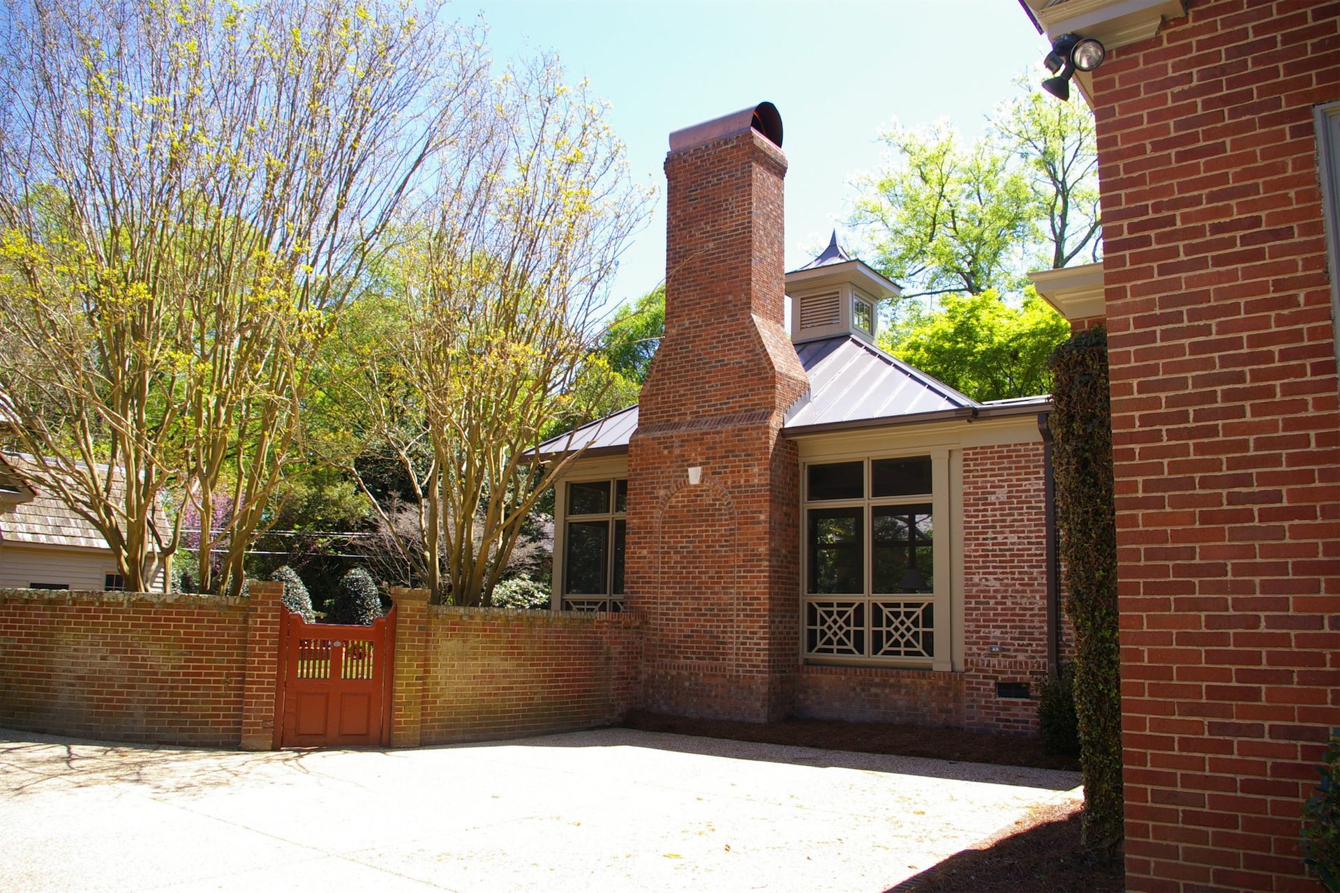 A brick house with a chimney on the side of it