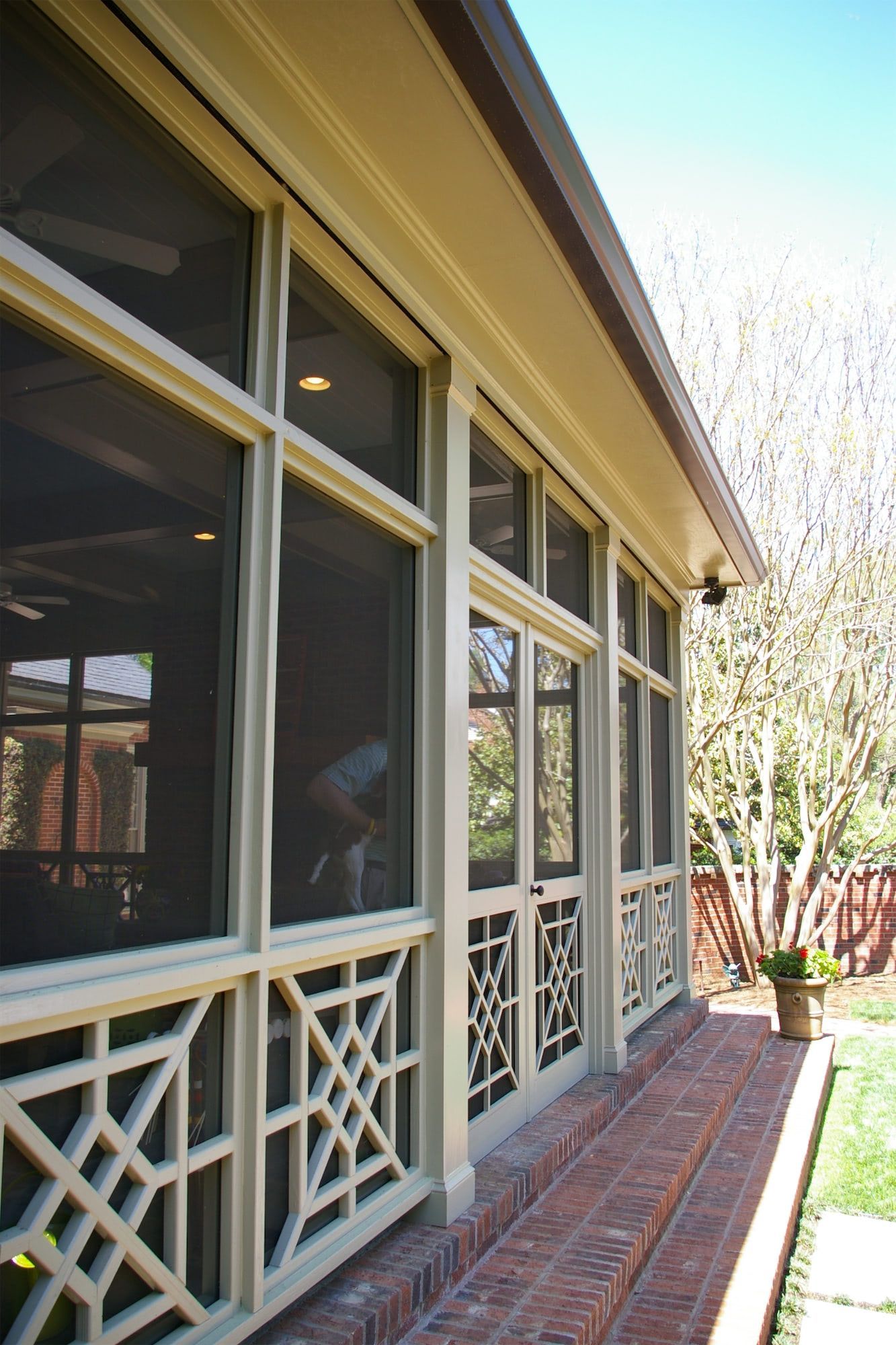 A screened in porch with a lot of windows