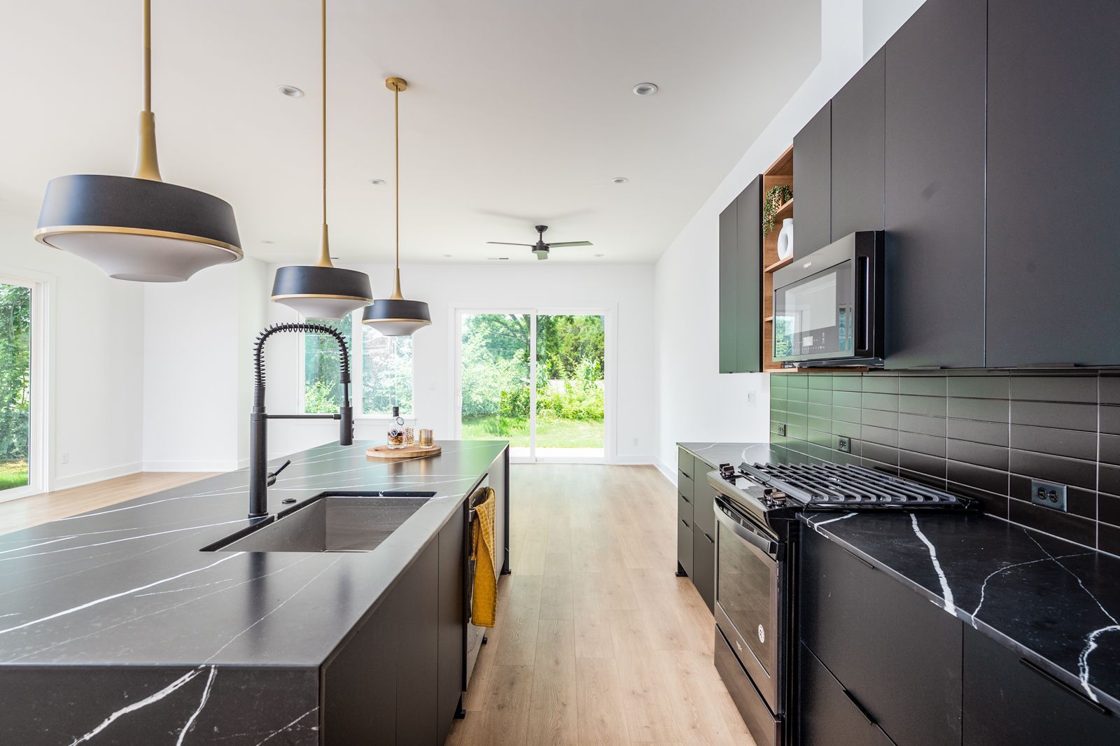 A kitchen with black cabinets and black counter tops