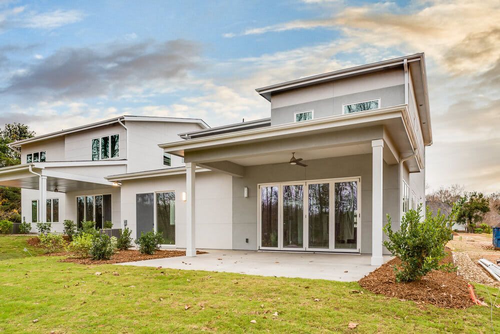 A large white house with a large lawn in front of it.