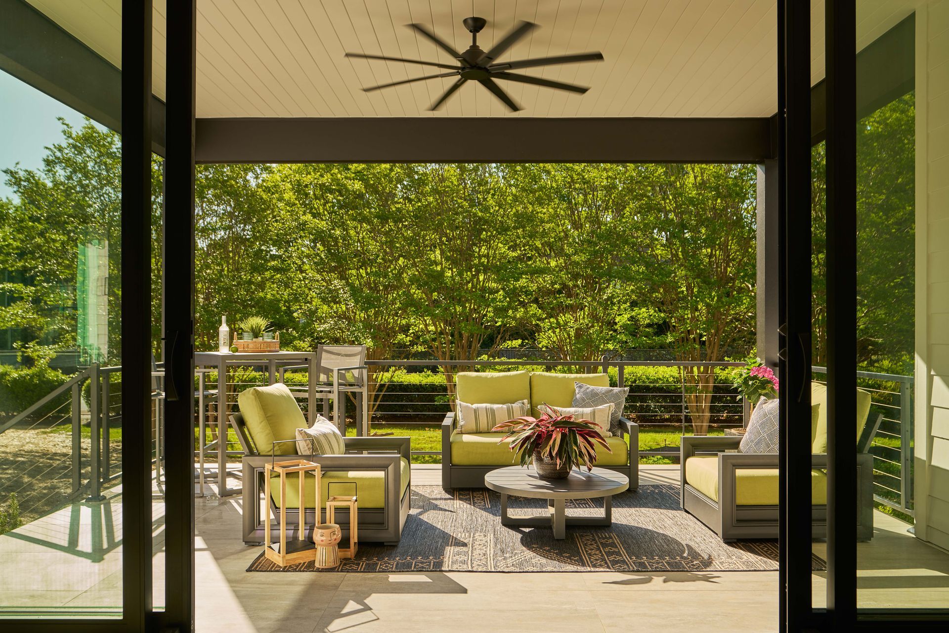 A patio with a ceiling fan and a lot of furniture