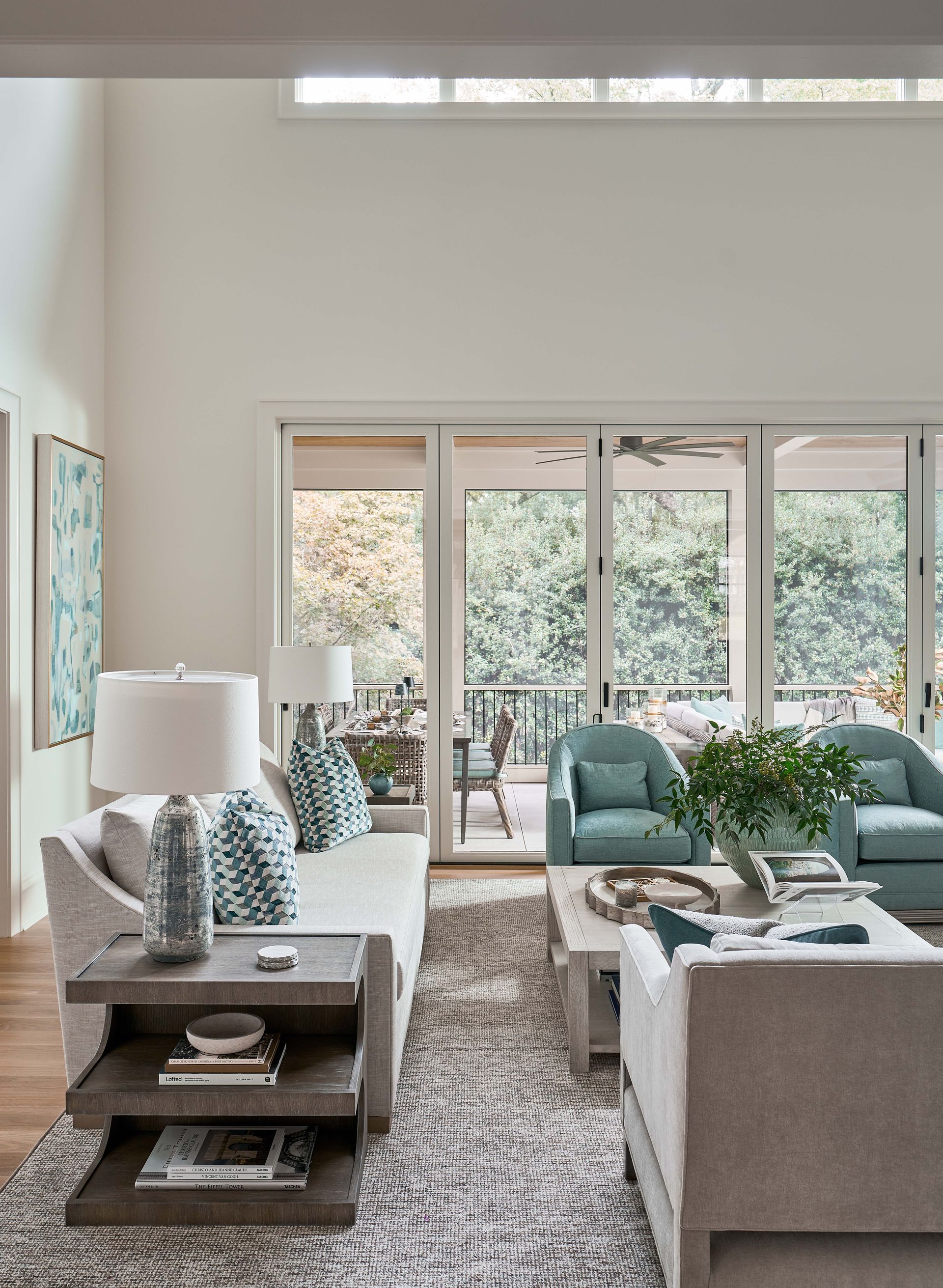 A living room with a couch , chair , table and lamps