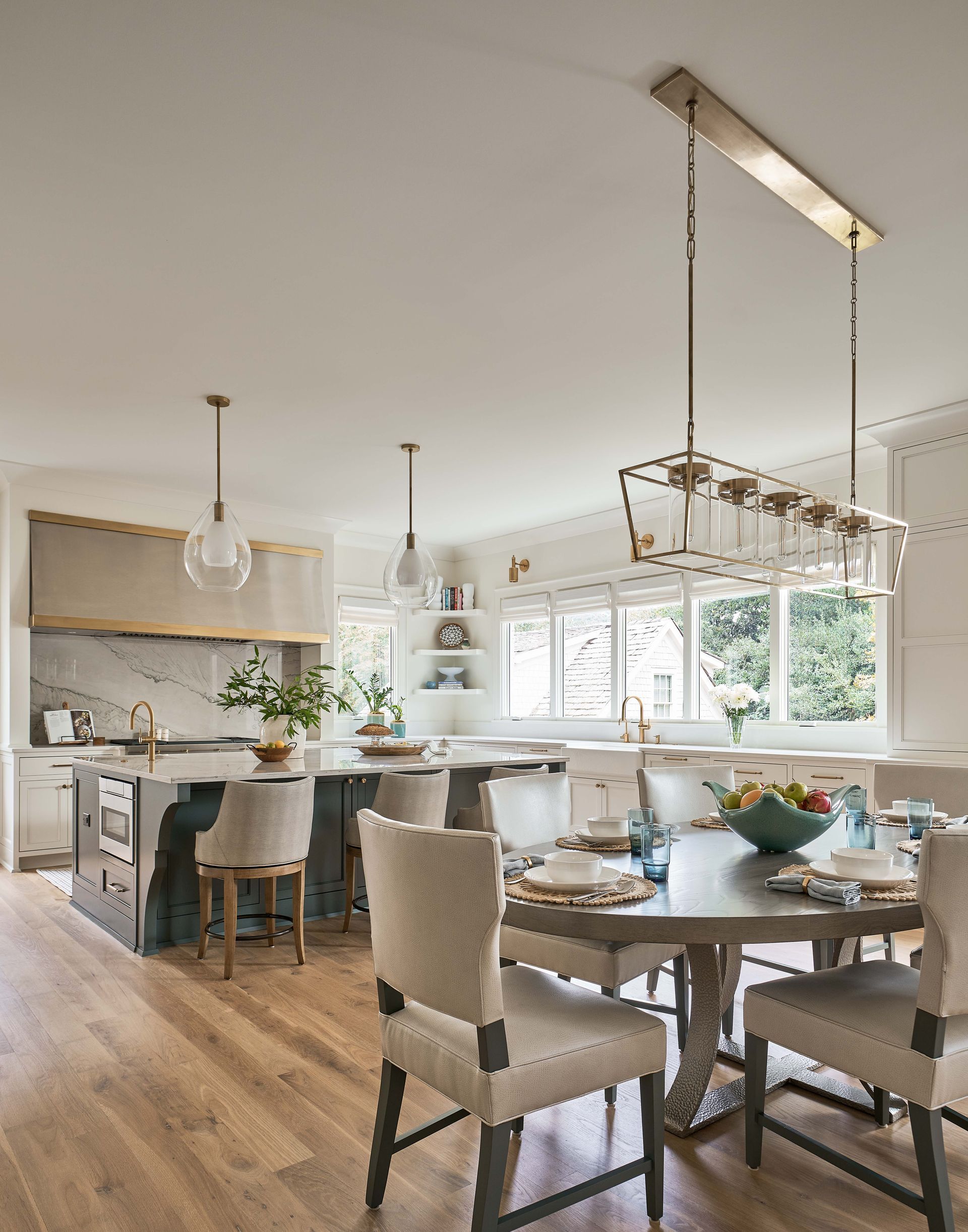 A kitchen and dining room in a house with a table and chairs.