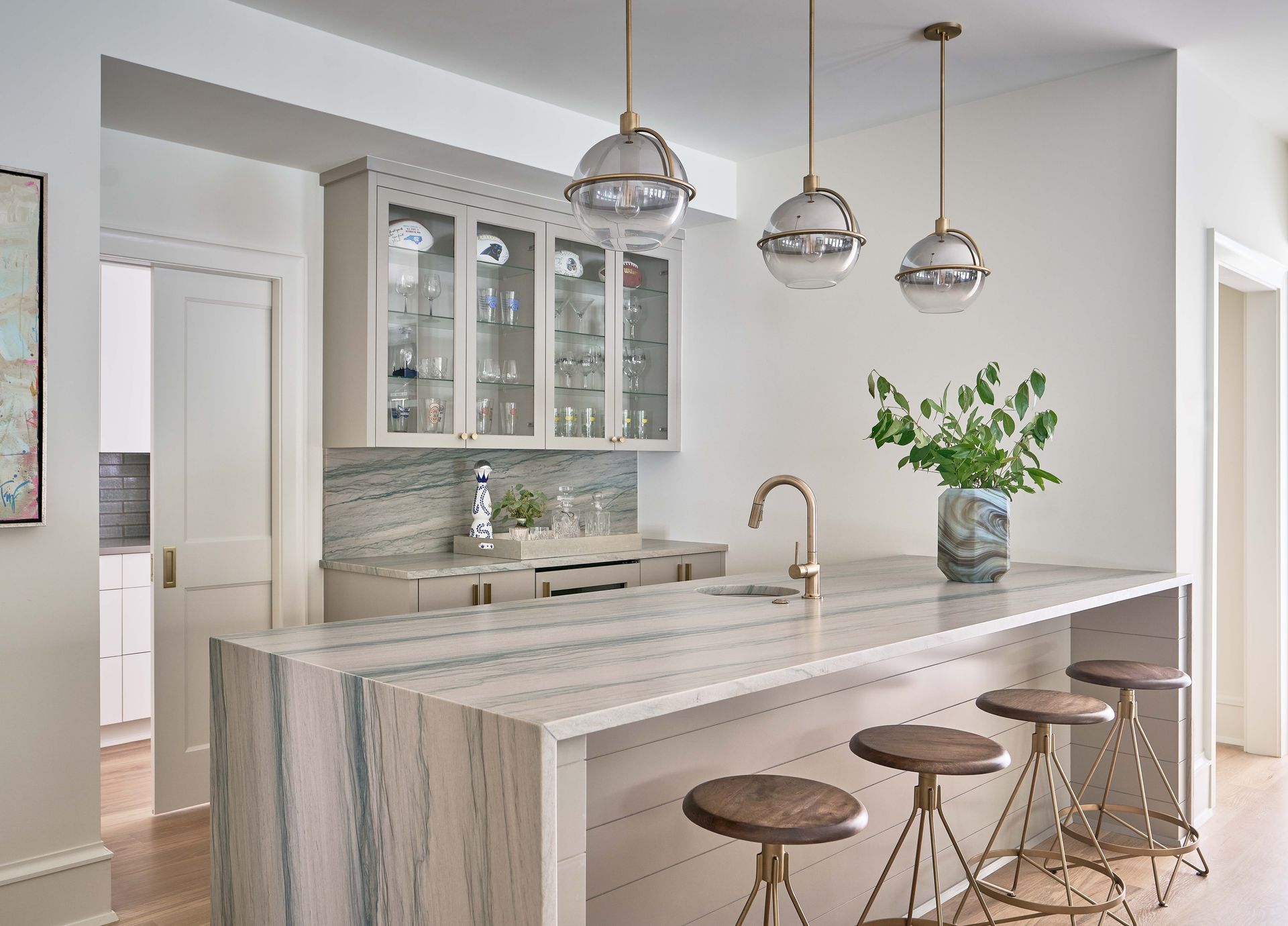 A kitchen with a large island and stools