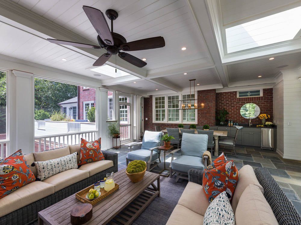 A living room with a ceiling fan and a couch.