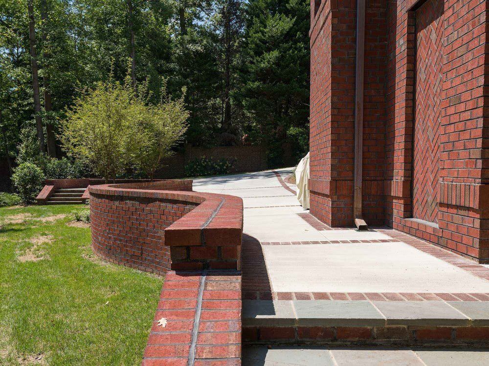 A brick building with a concrete walkway leading to it
