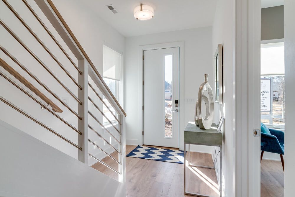a hallway with stairs leading up to the second floor of a house
