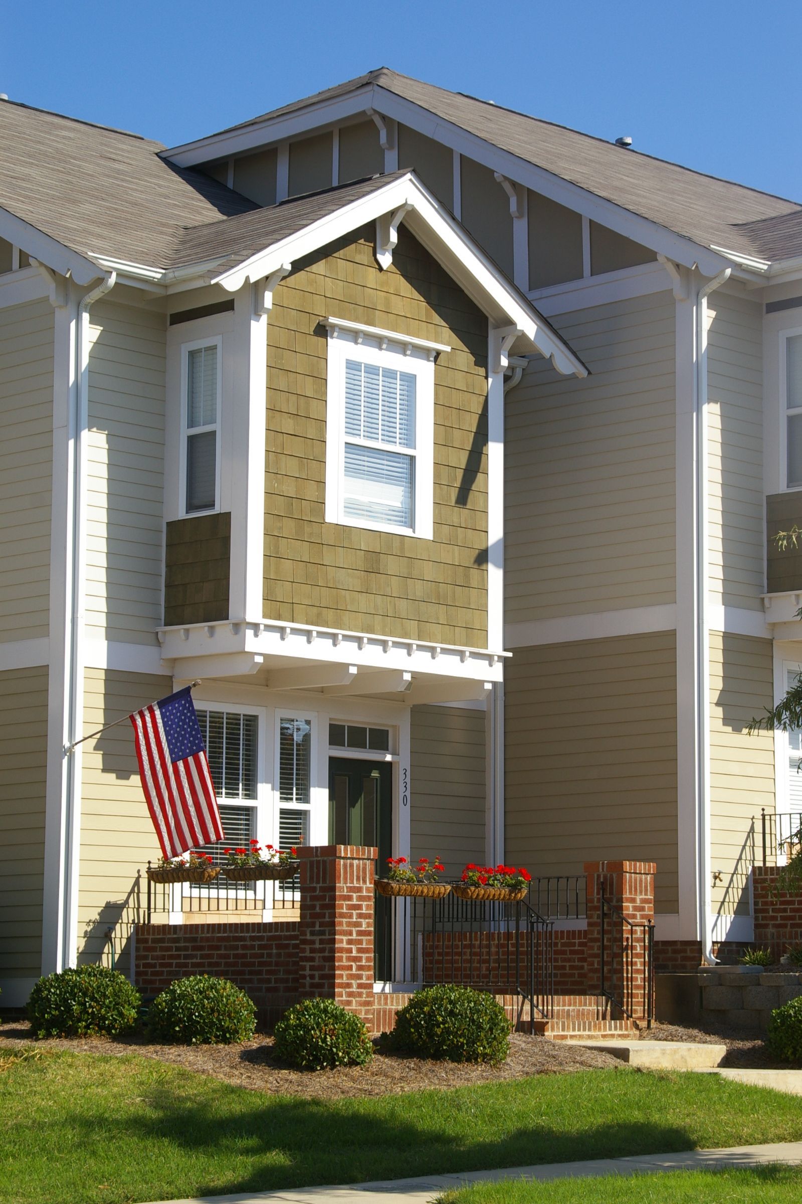 A house with an american flag on the front porch