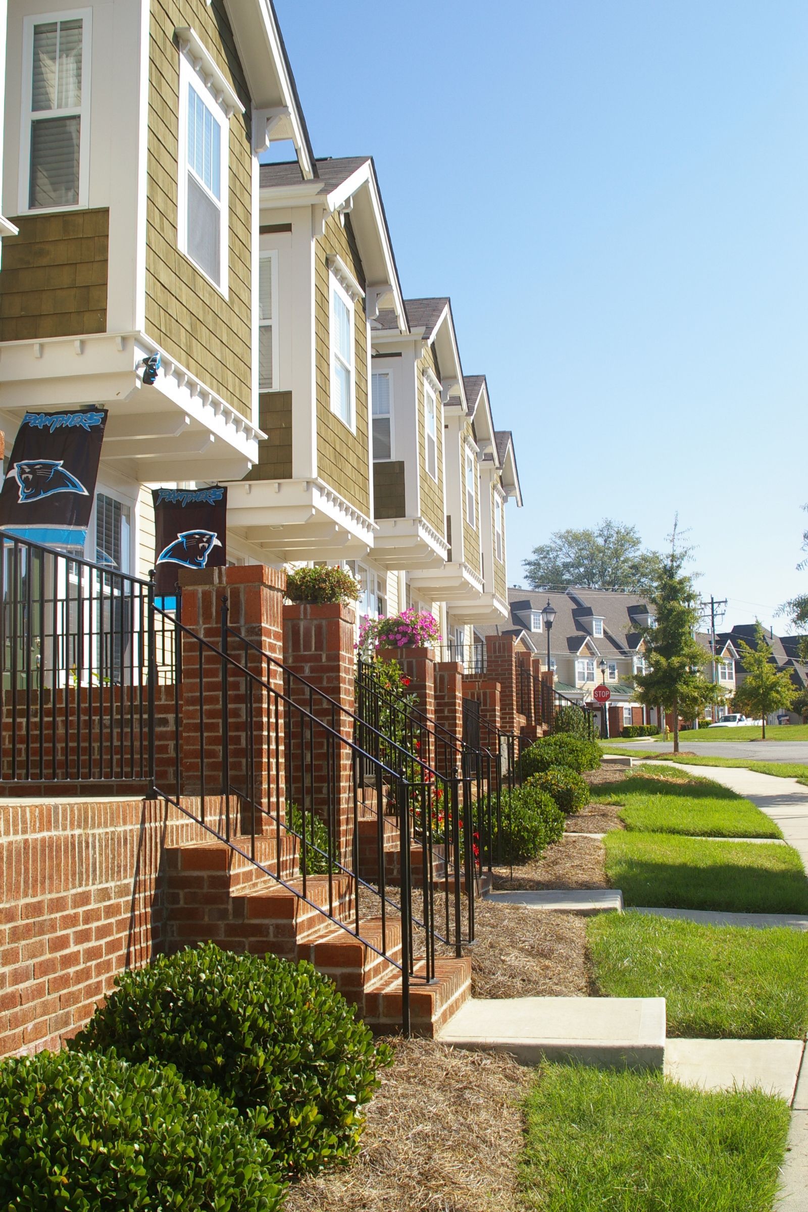 A row of houses on a sunny day with a sign that says ' atlanta ' on it