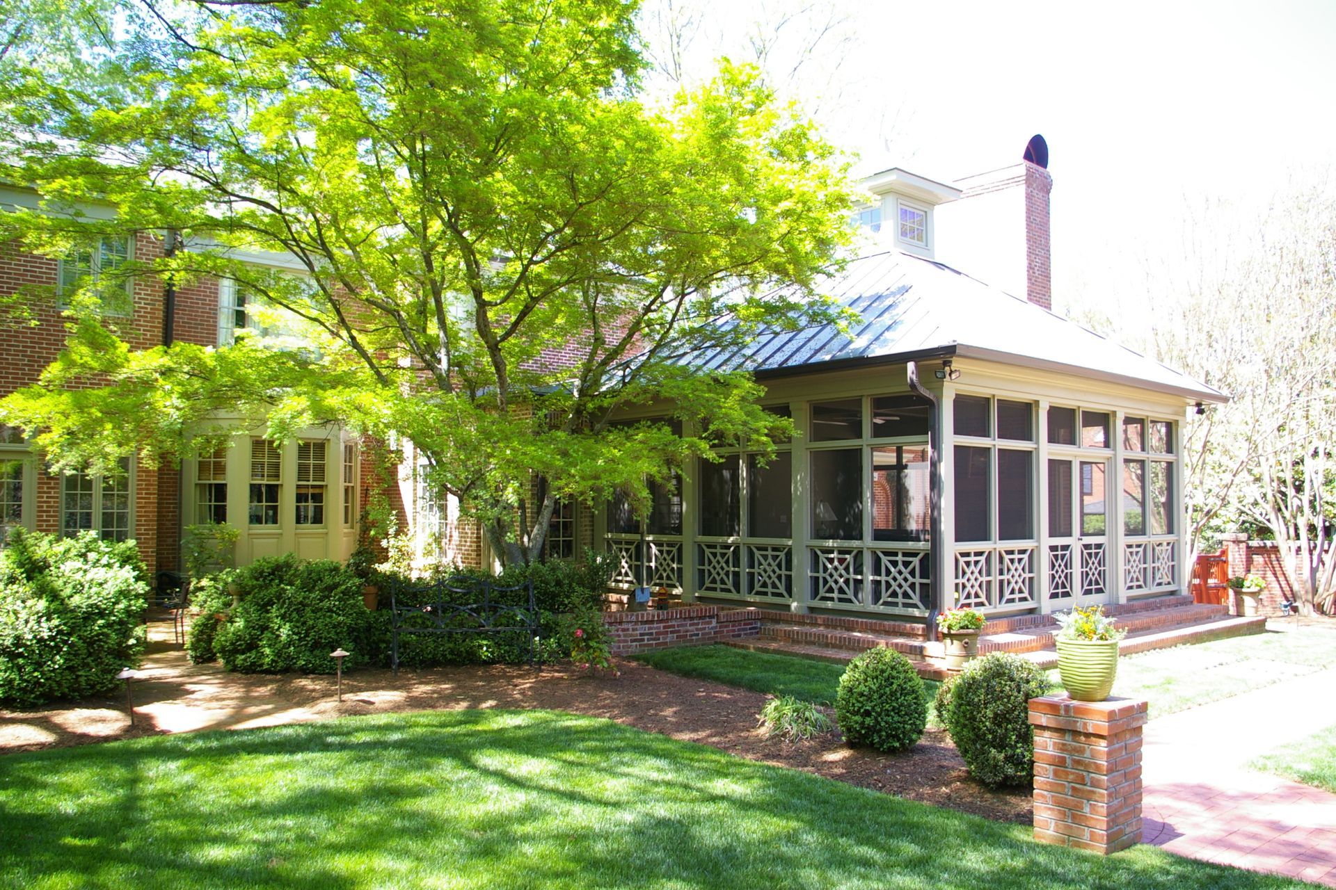 a house with a screened in porch in front of it