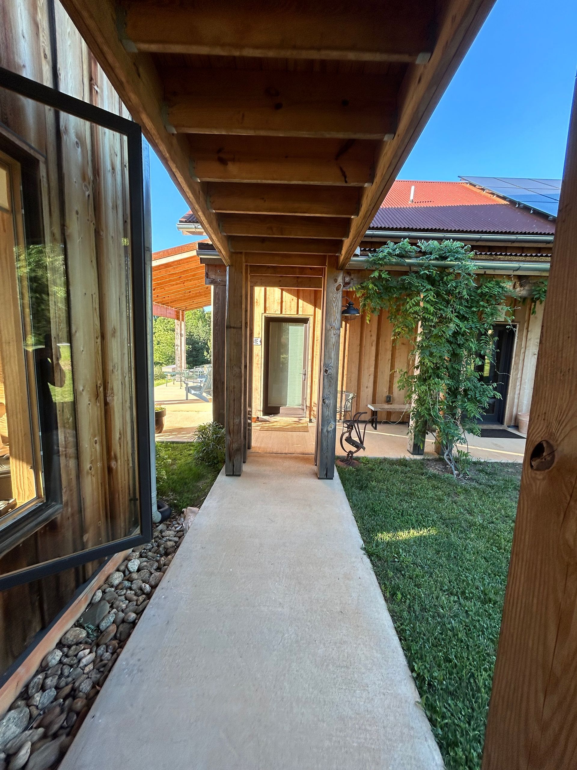 A wooden house with a covered walkway leading to it