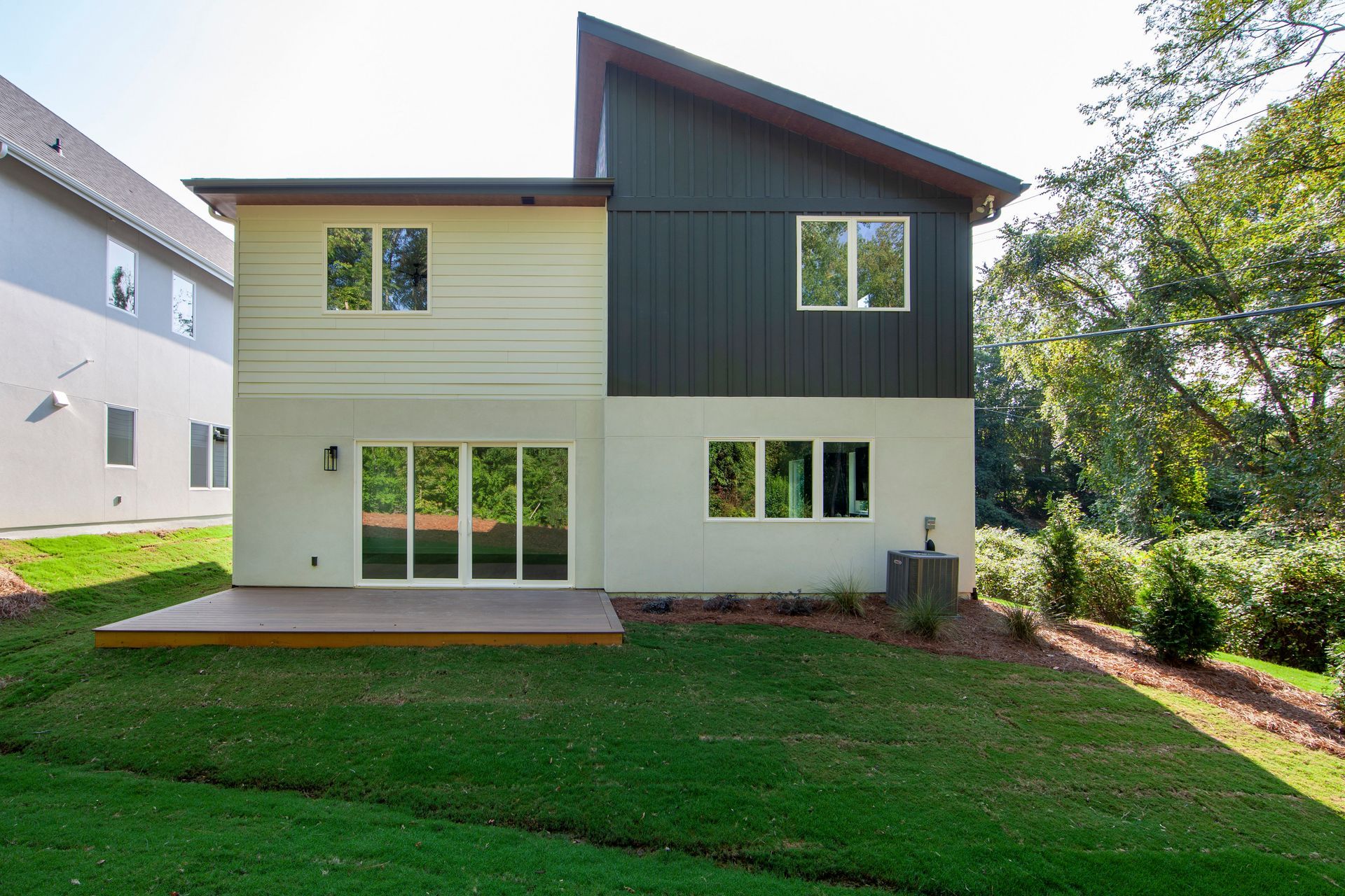 The back of a house with a large lawn in front of it