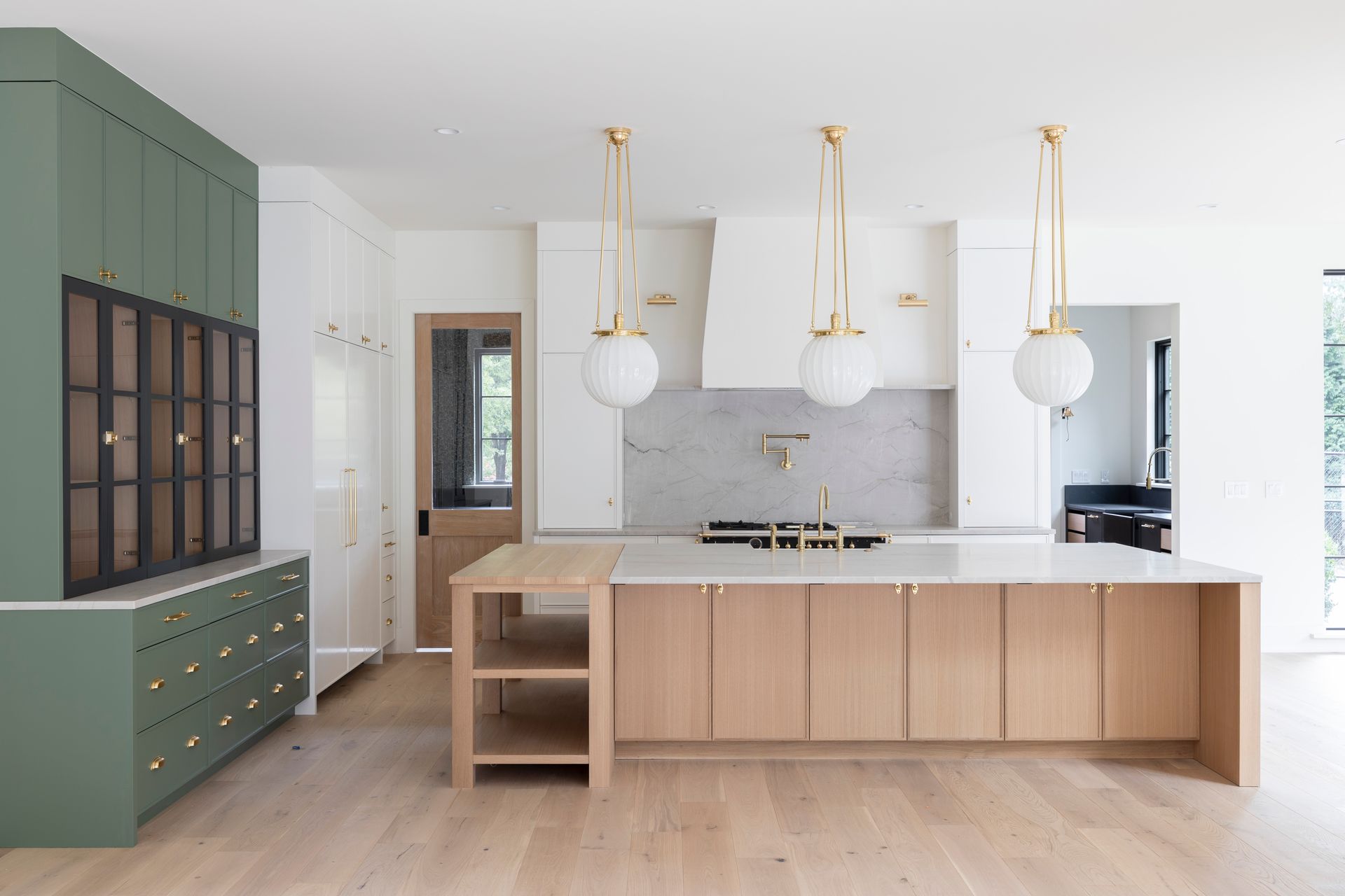 A kitchen with wooden cabinets and a large island.