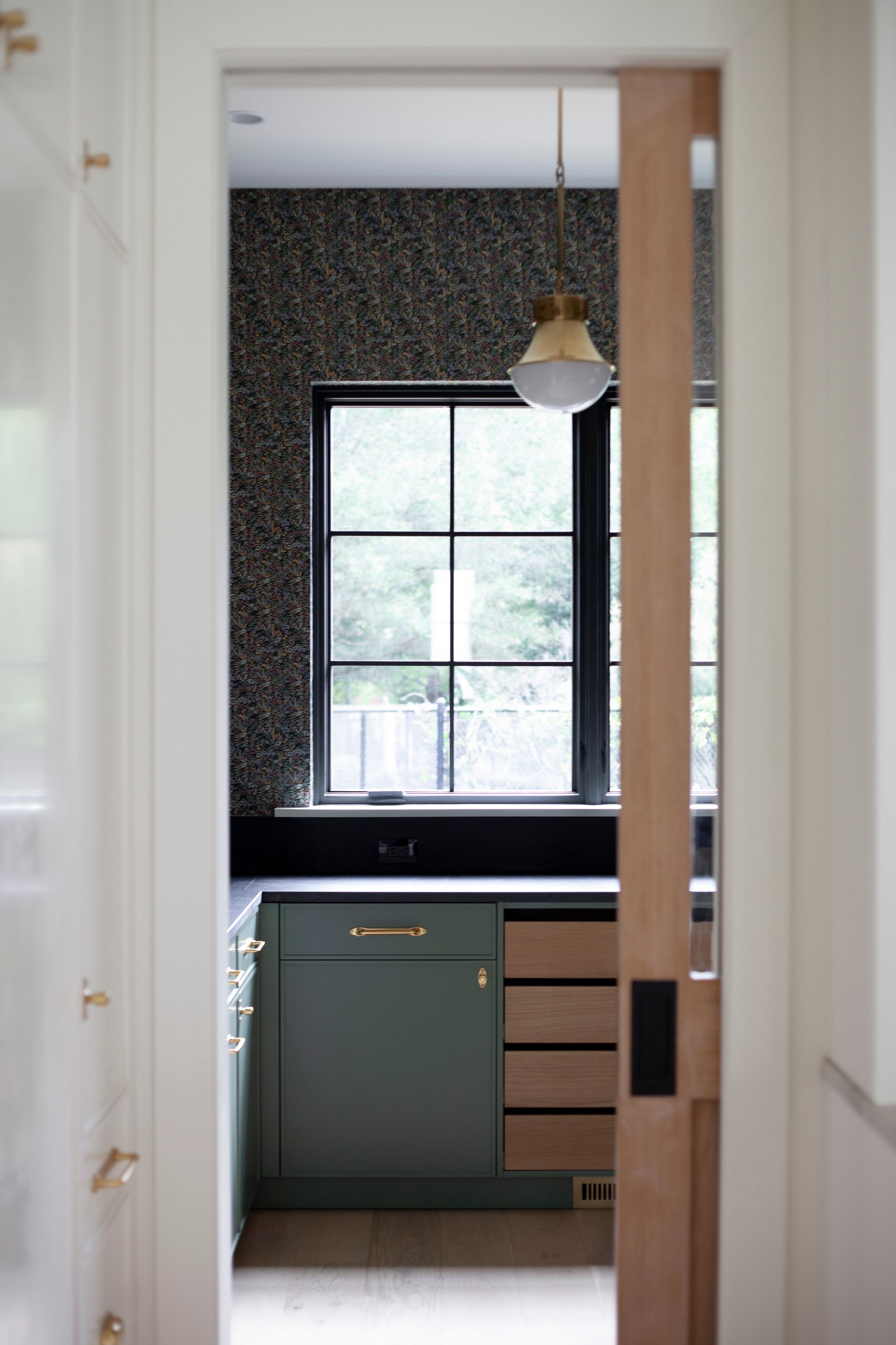 A view of a kitchen through a sliding glass door.
