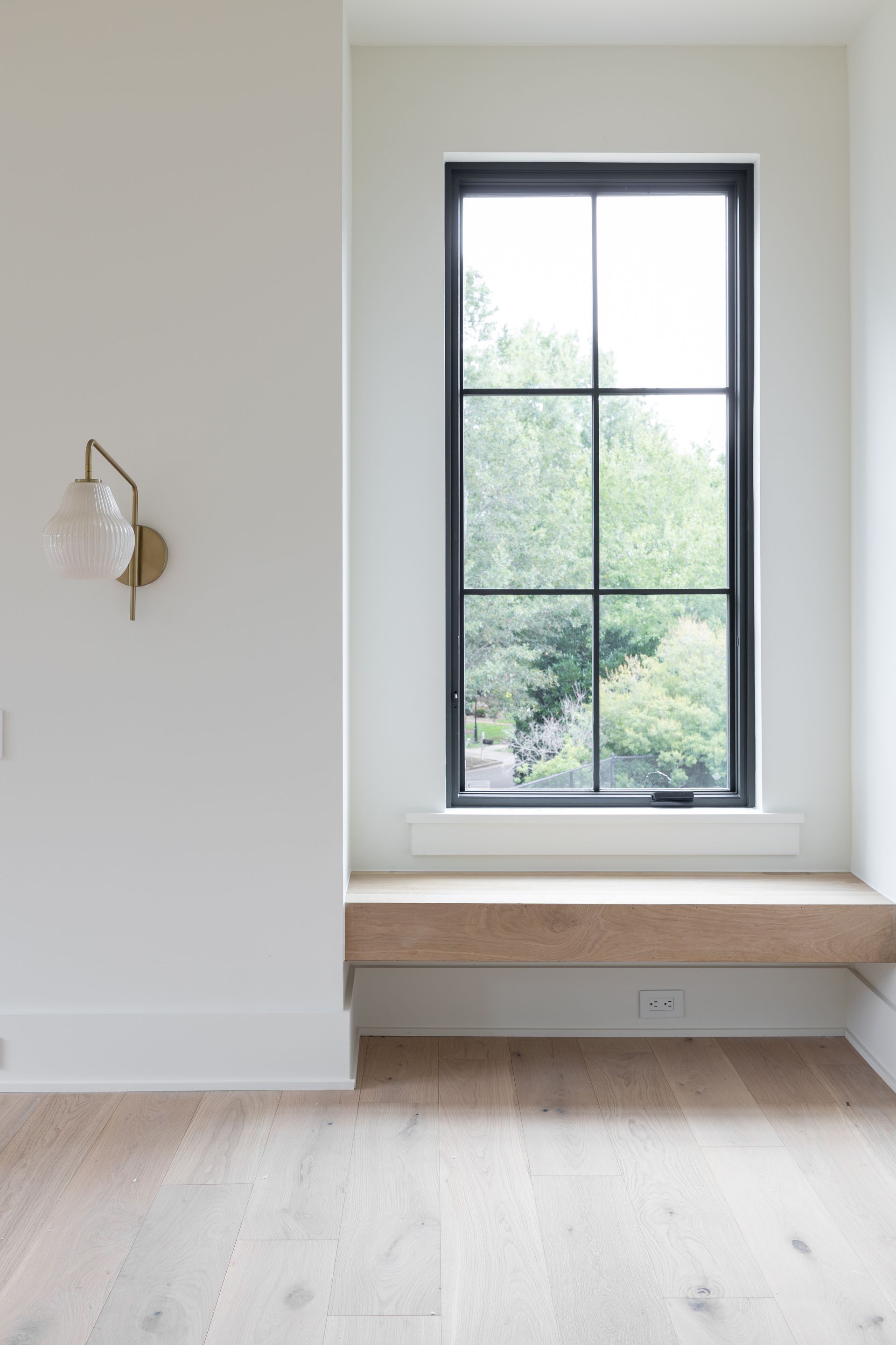 There is a window seat in the corner of the room.