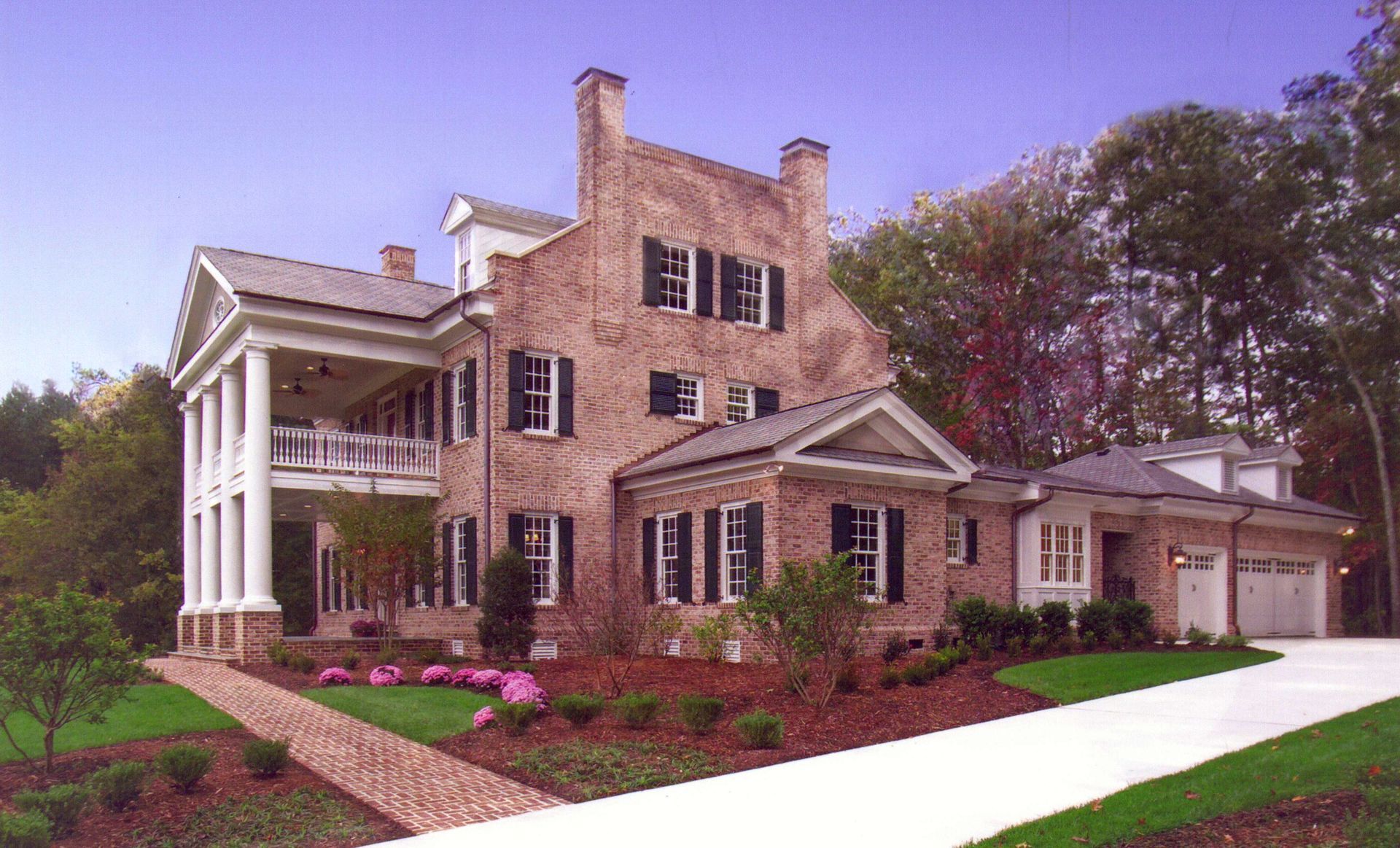 A large brick house with white trim and black shutters