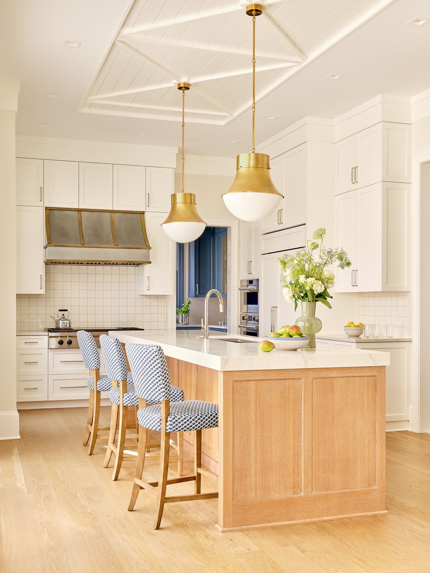 A kitchen with a large island and stools