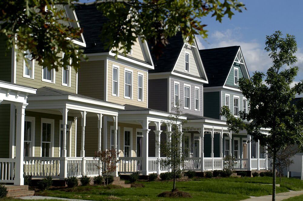 a row of houses with porches on a sunny day