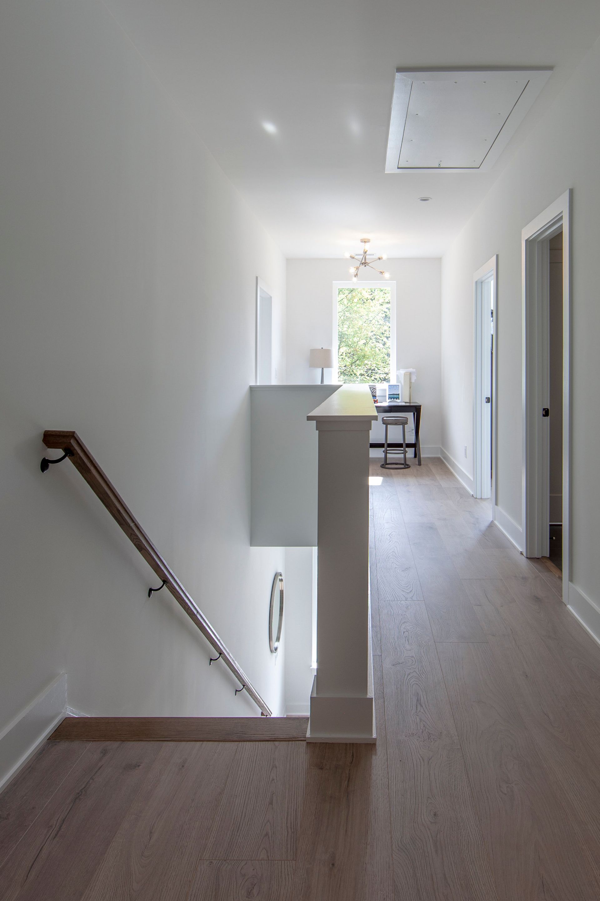 A hallway with stairs leading up to the second floor of a house