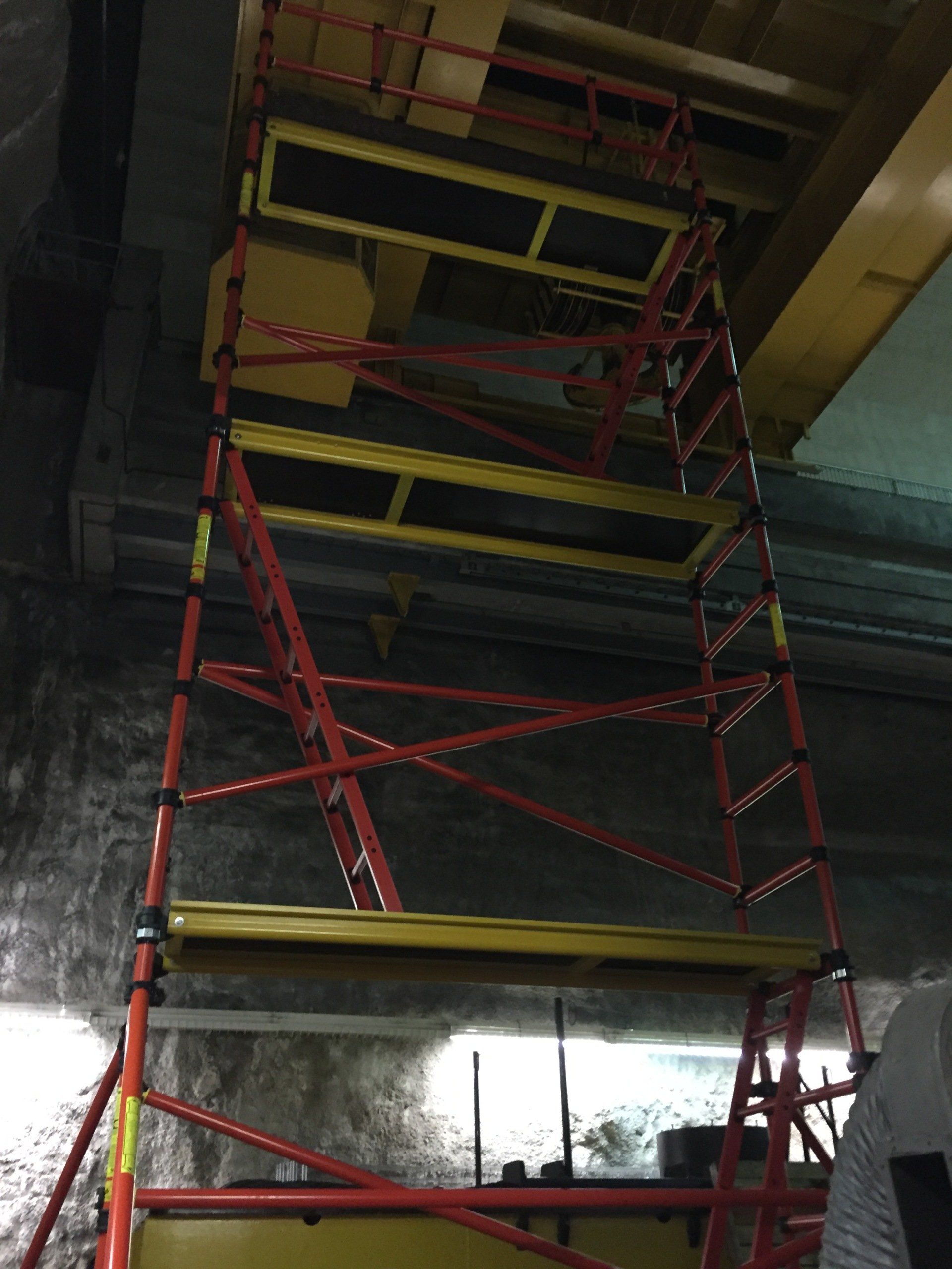 A red and yellow scaffolding in a dark room
