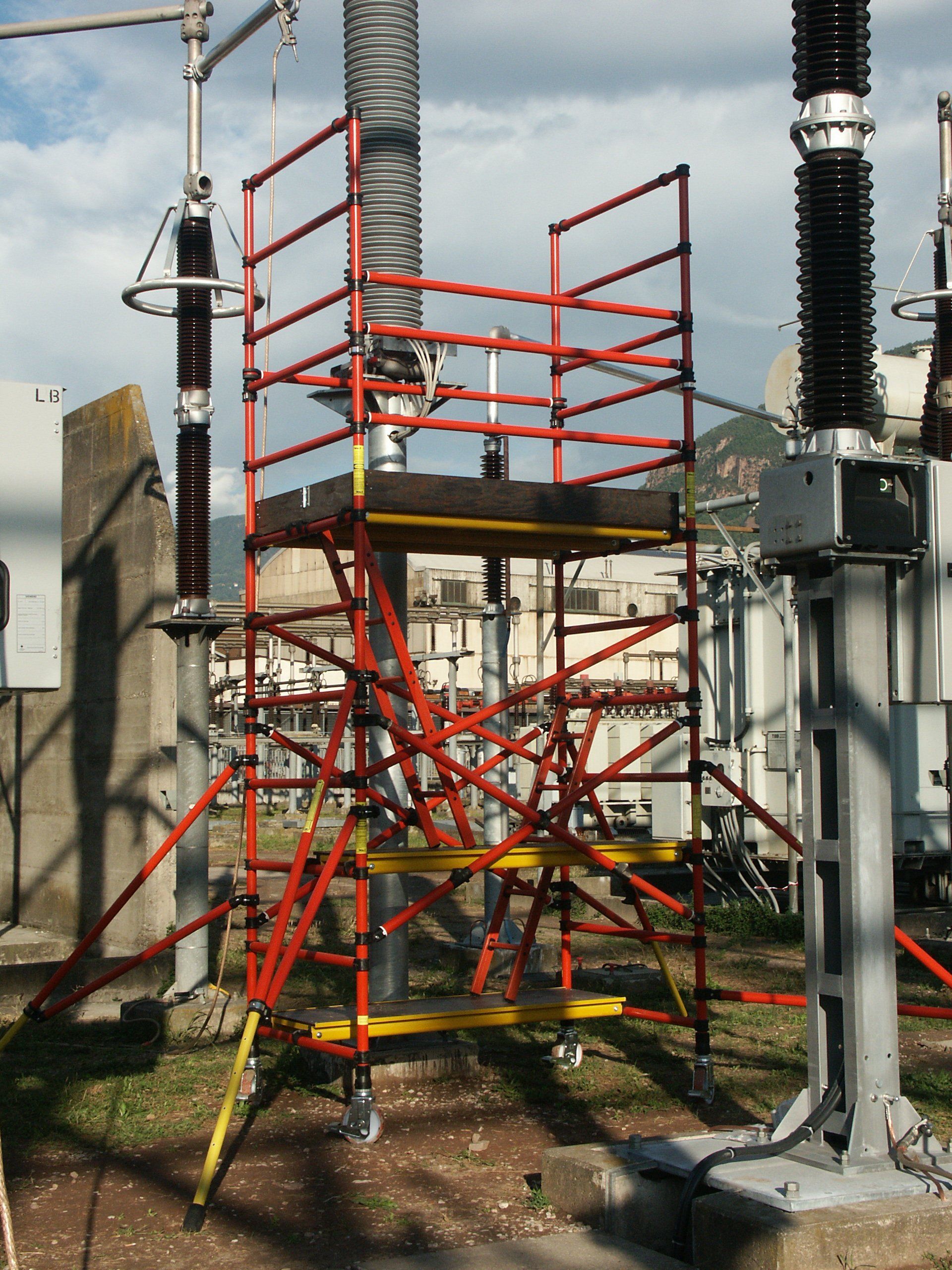 A red and yellow scaffolding in a electrical area