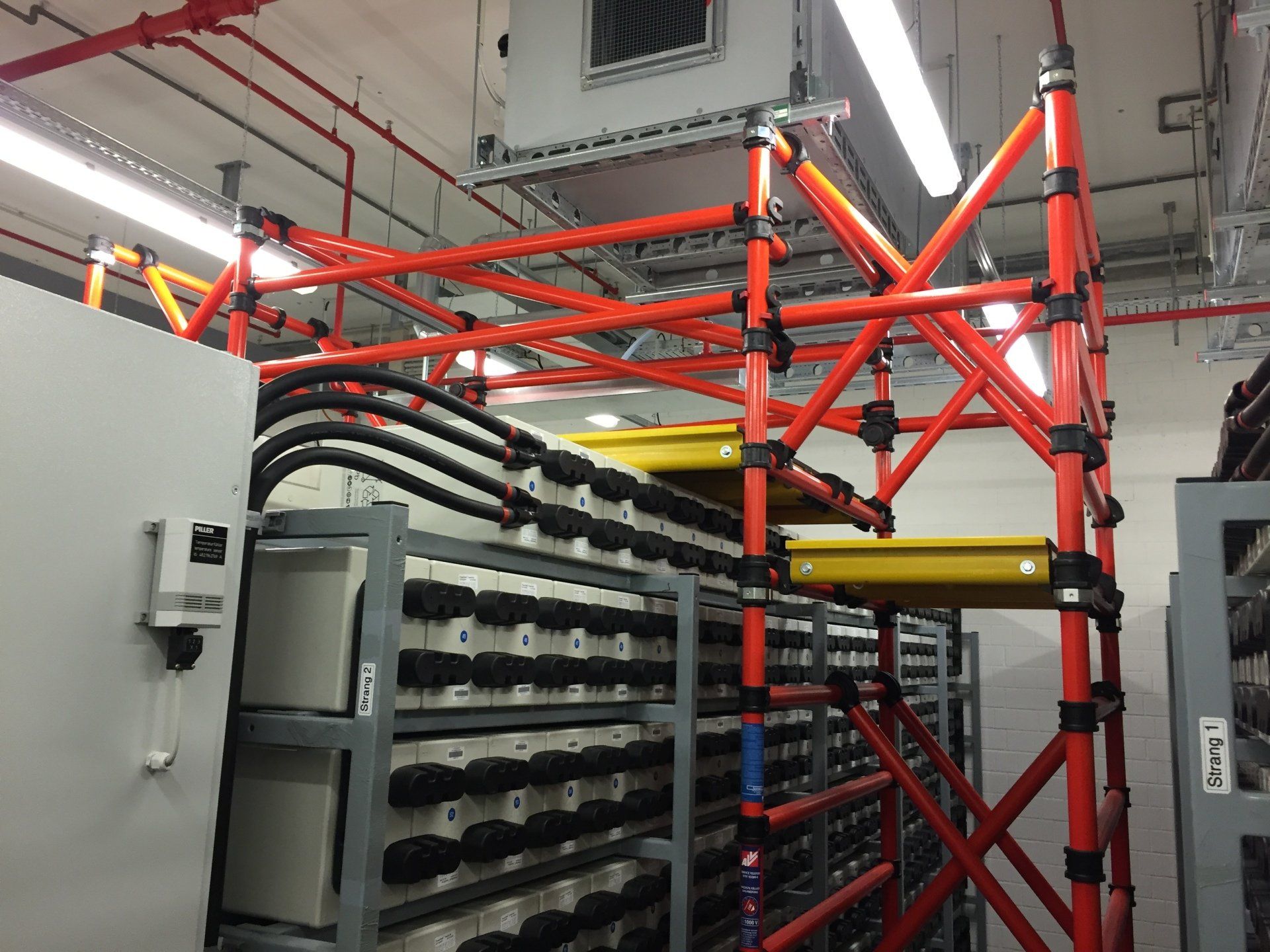 A room with a bunch of electrical wires hanging from the ceiling