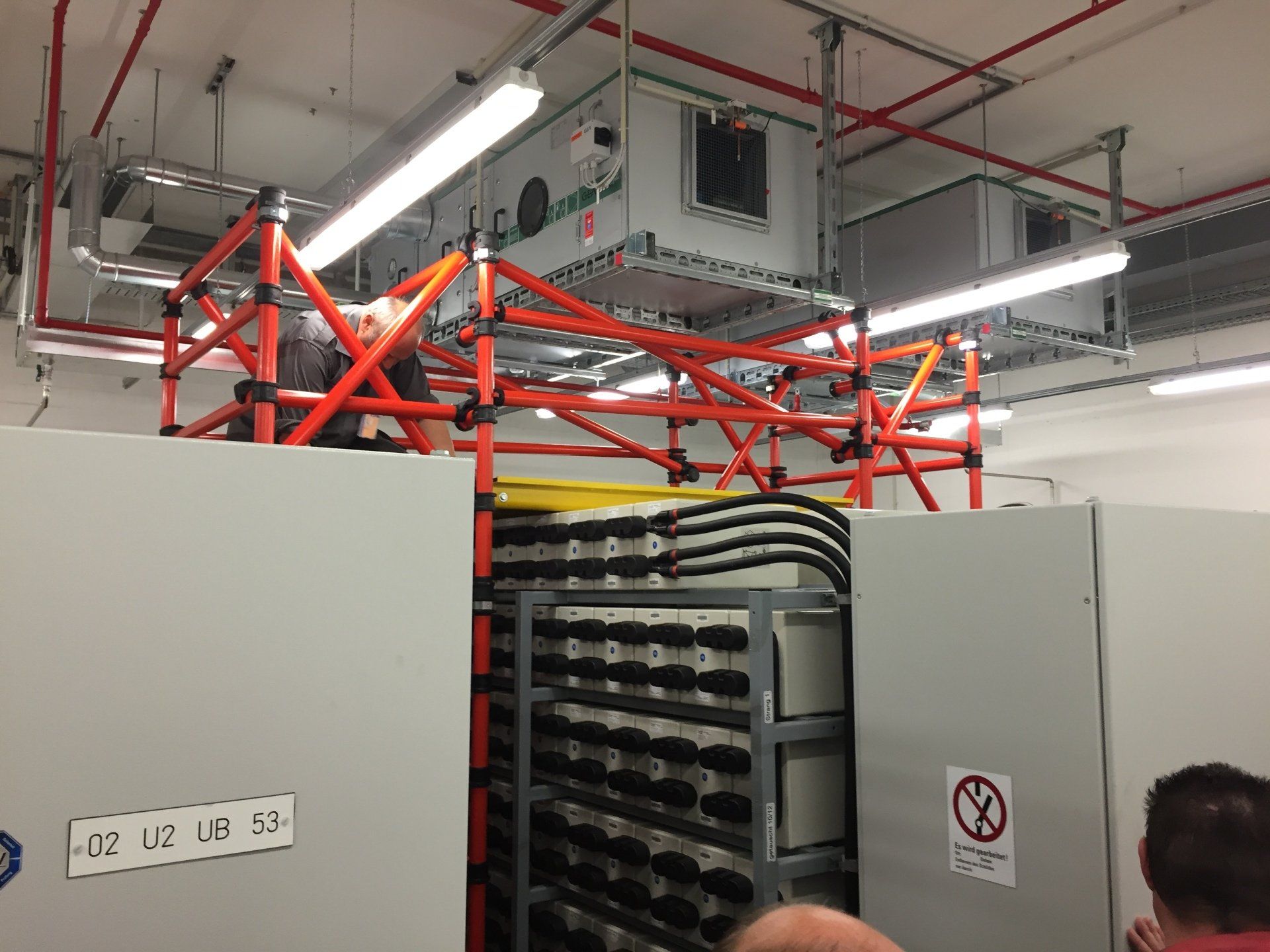 A man is standing in a room with a sign that says do not enter