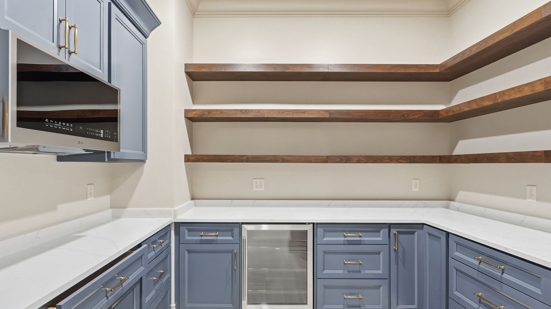 Blue pantry with white countertops, open wooden shelves, and a built-in wine cooler.
