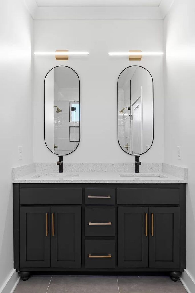 A bathroom with two sinks and two mirrors.