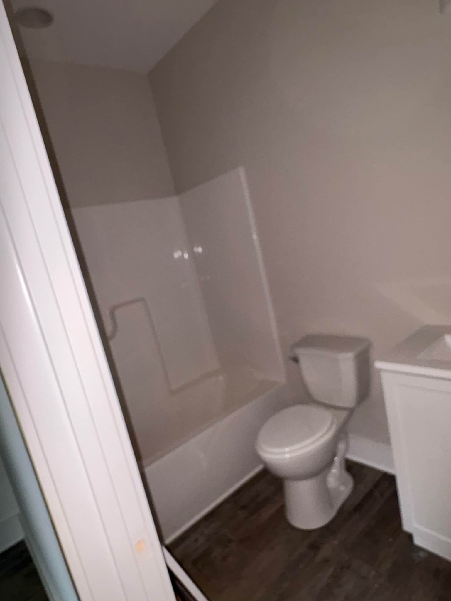 A bathroom with a toilet , sink and bathtub.